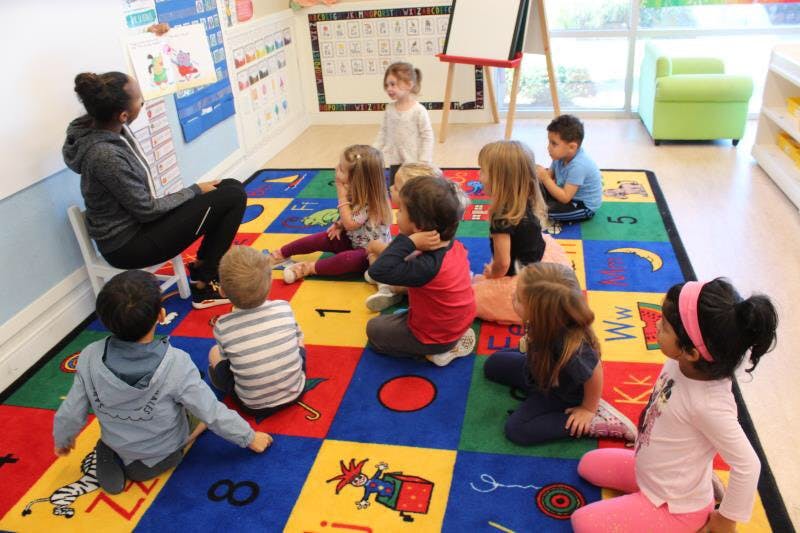 Person reading to children in a classroom