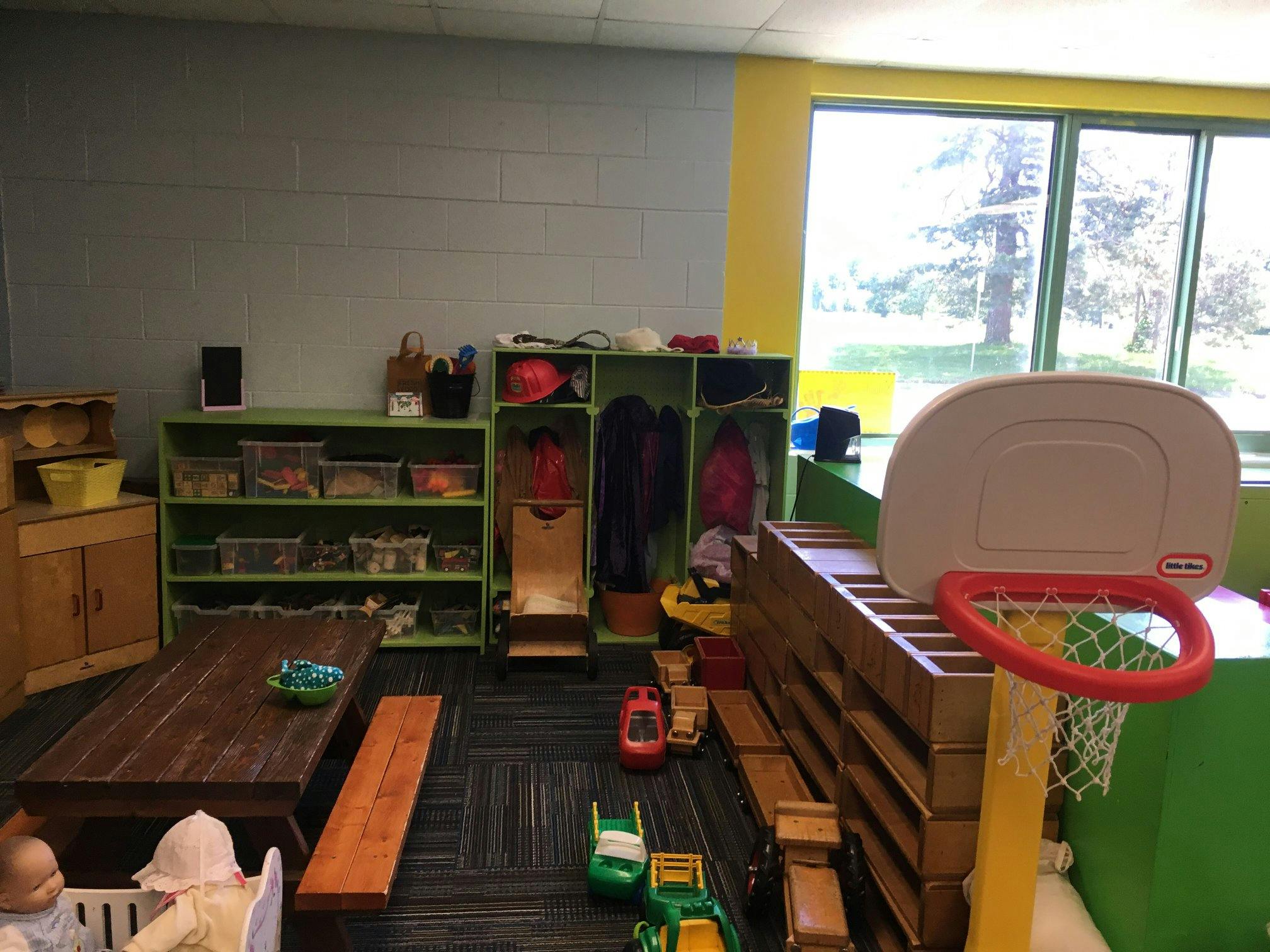 Playroom with shelves, table, and toy basketball hoop