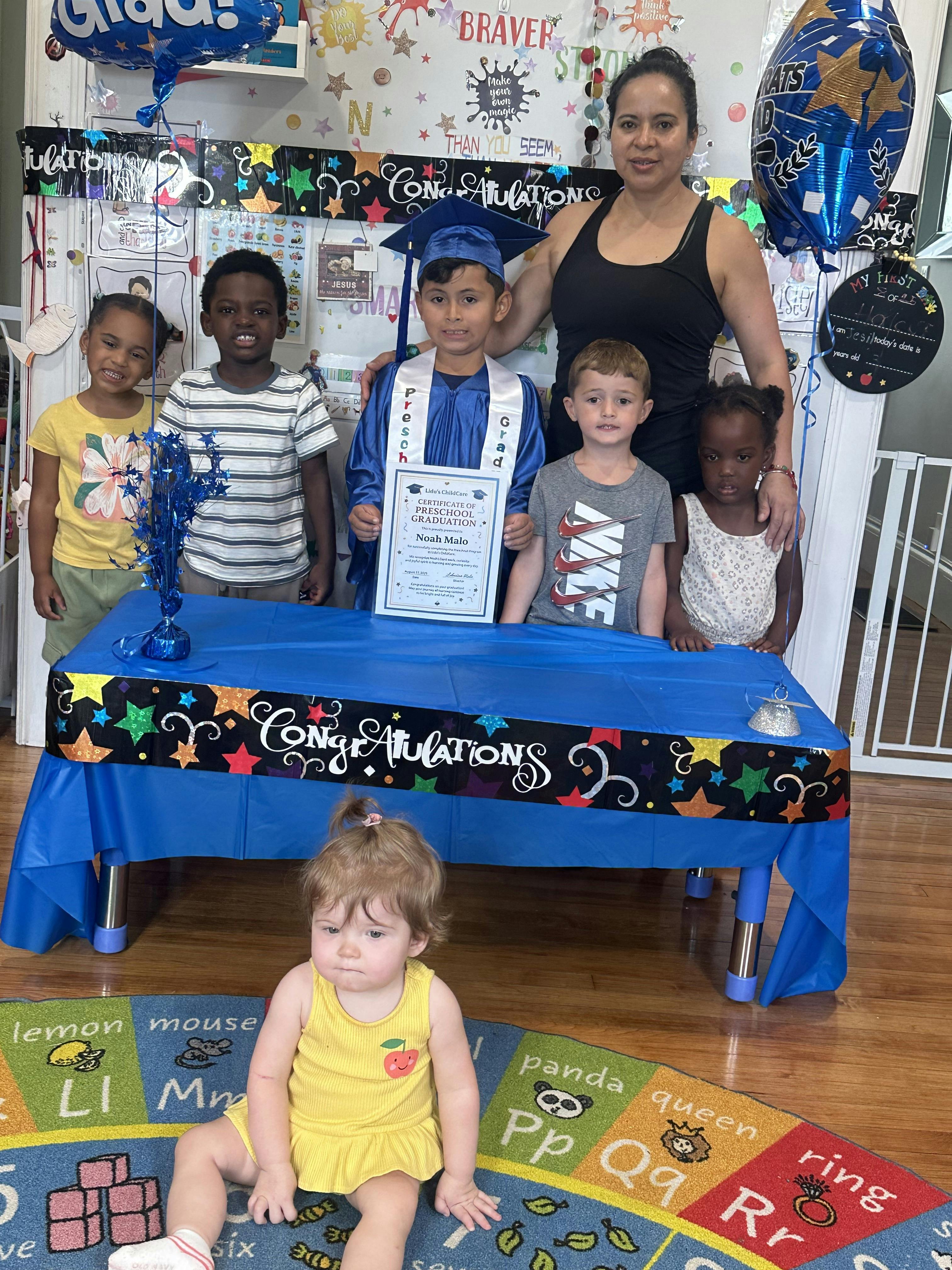 Adult and children posing for a photo, one child in graduation attire