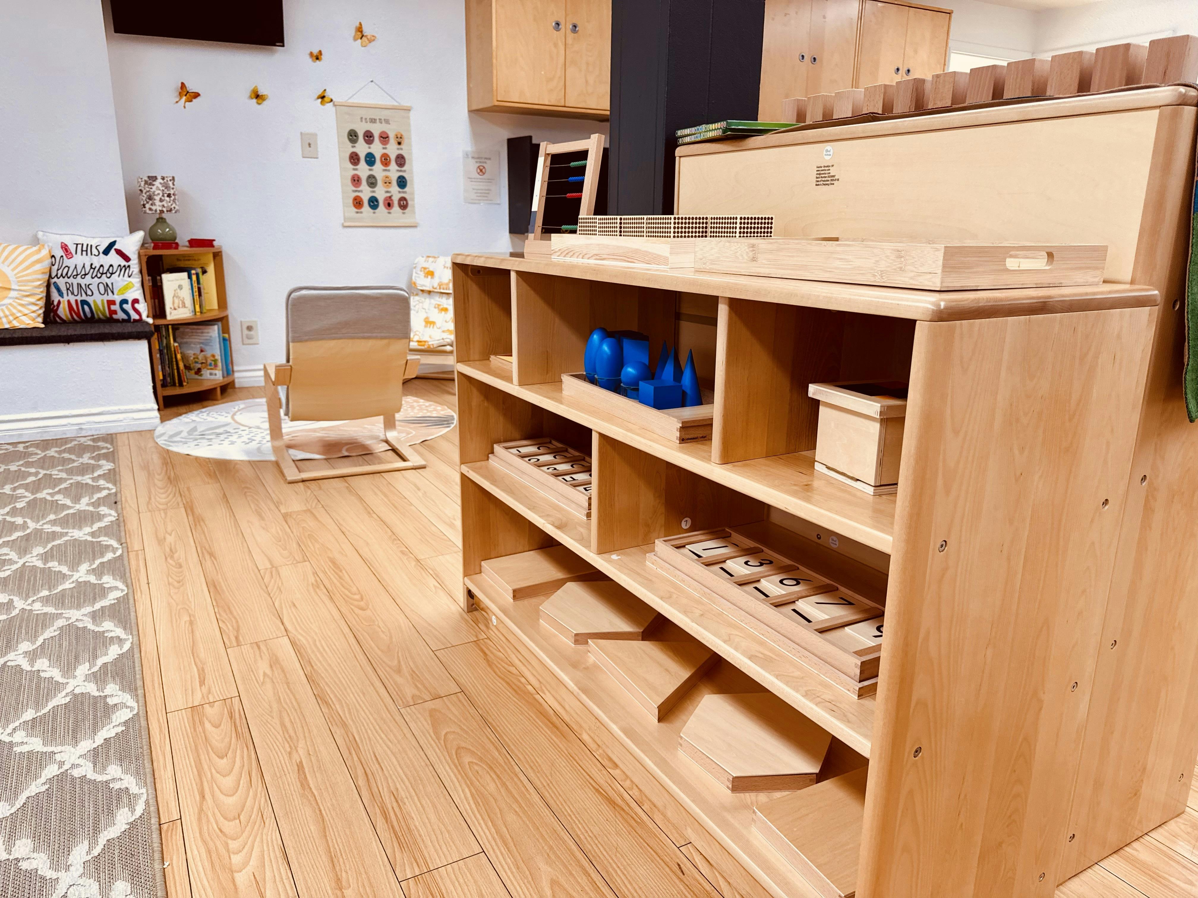 Wooden shelving unit with educational materials in a classroom