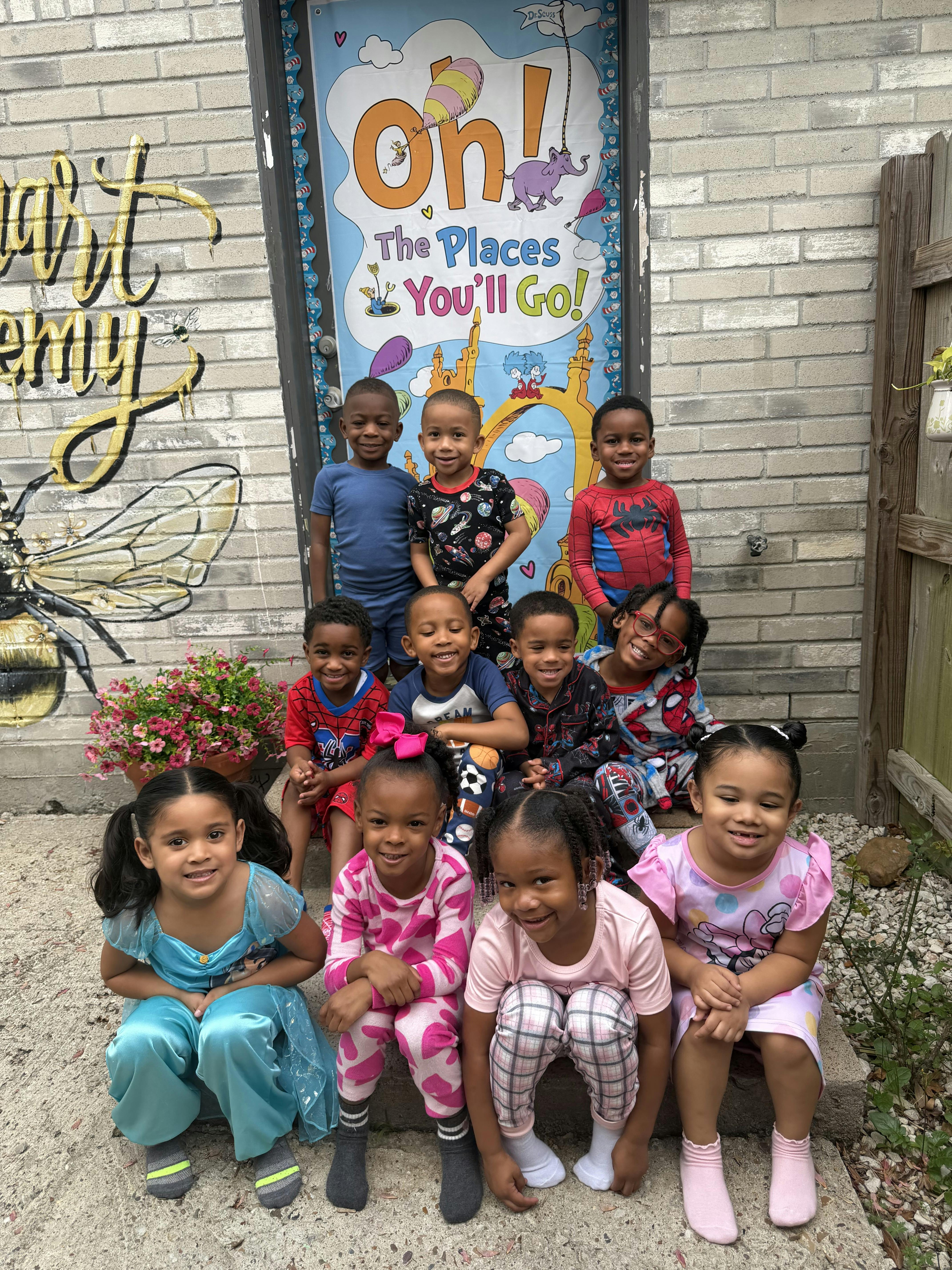 Group of children posing in front of a decorated door