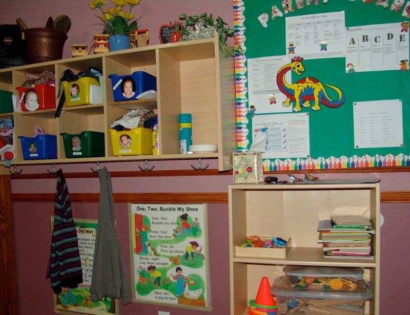 Classroom with cubbies, bulletin board, and shelves