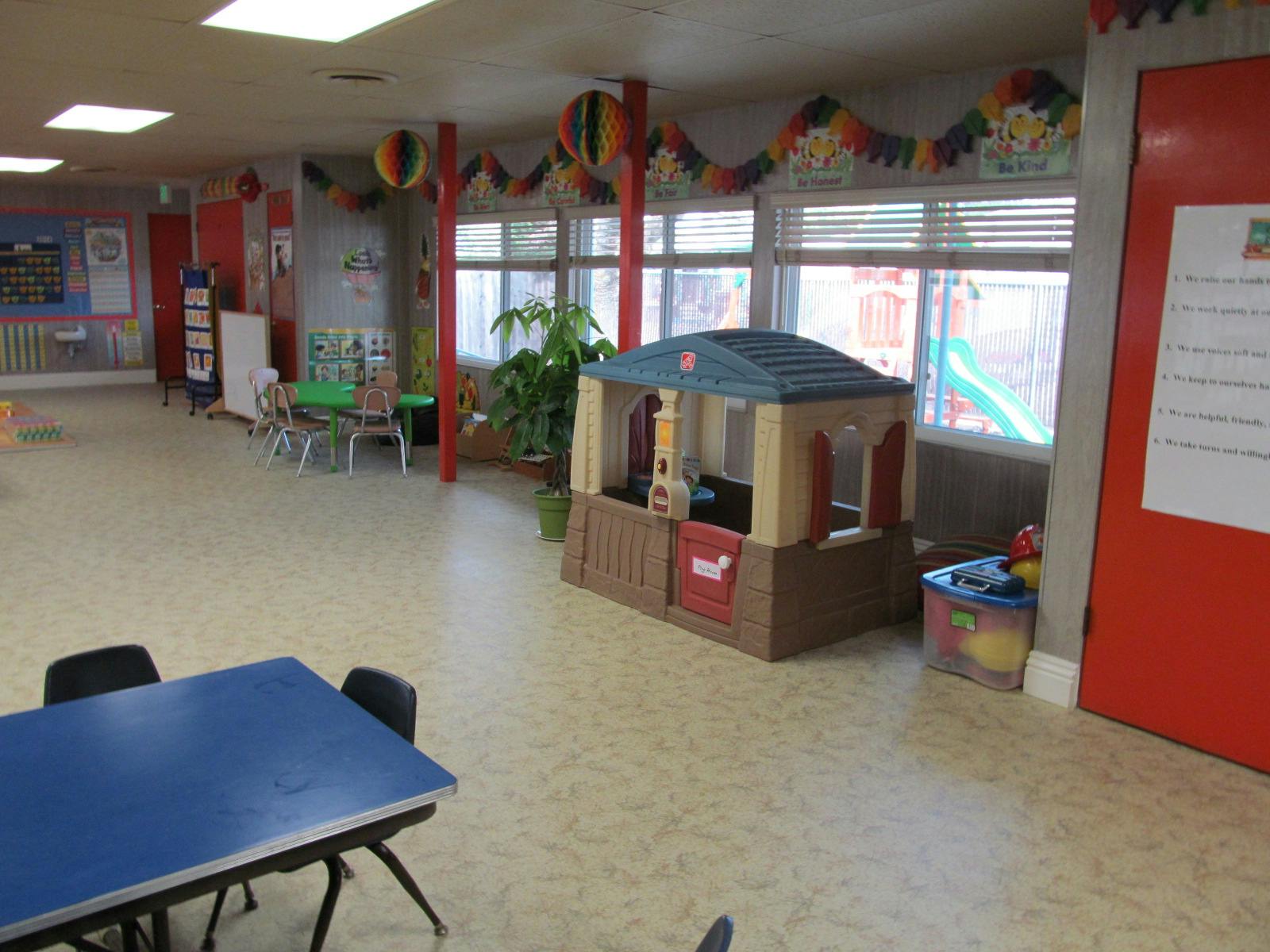 Playroom with a toy house and tables