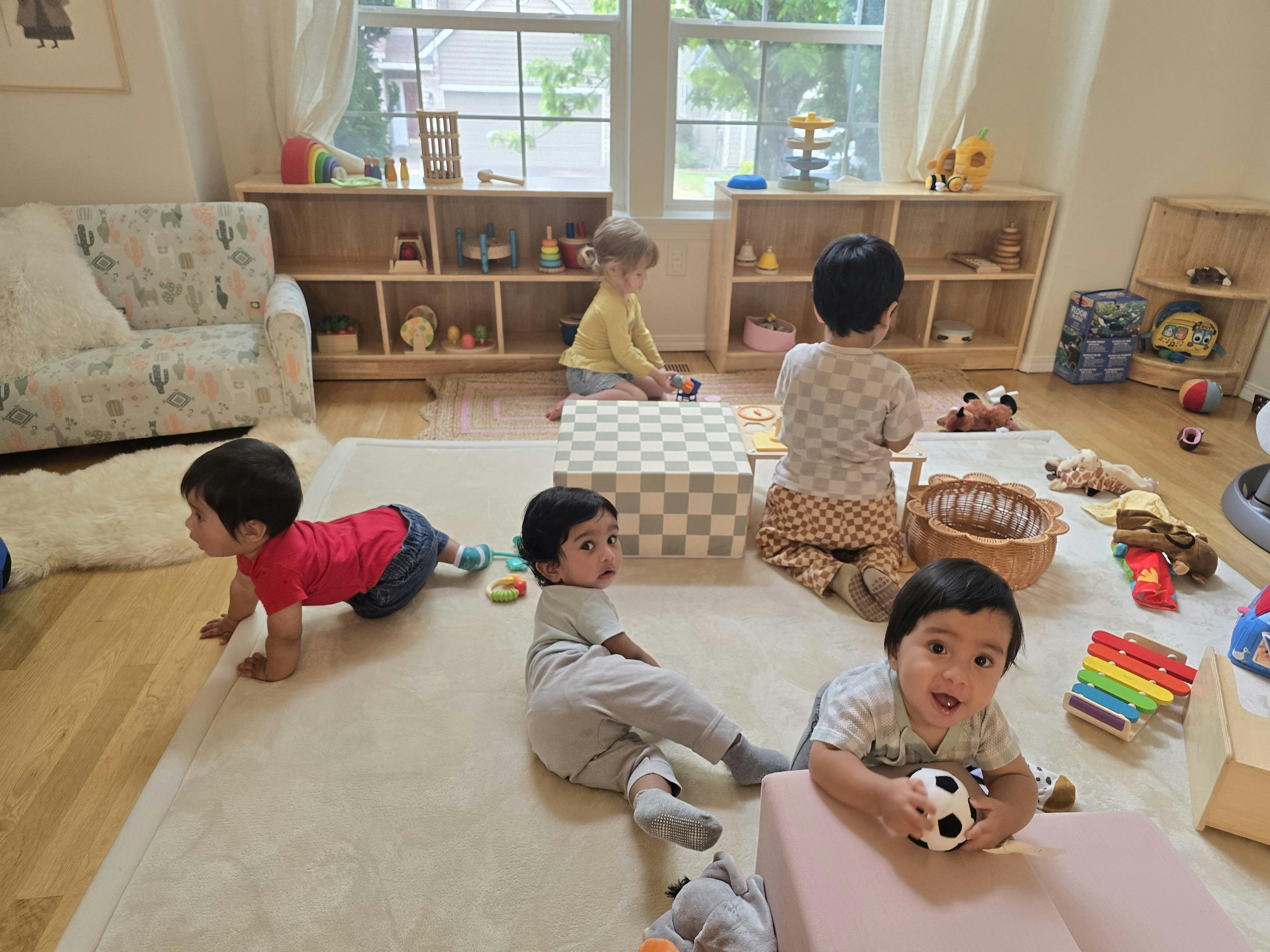 Children playing with toys on the floor in a playroom