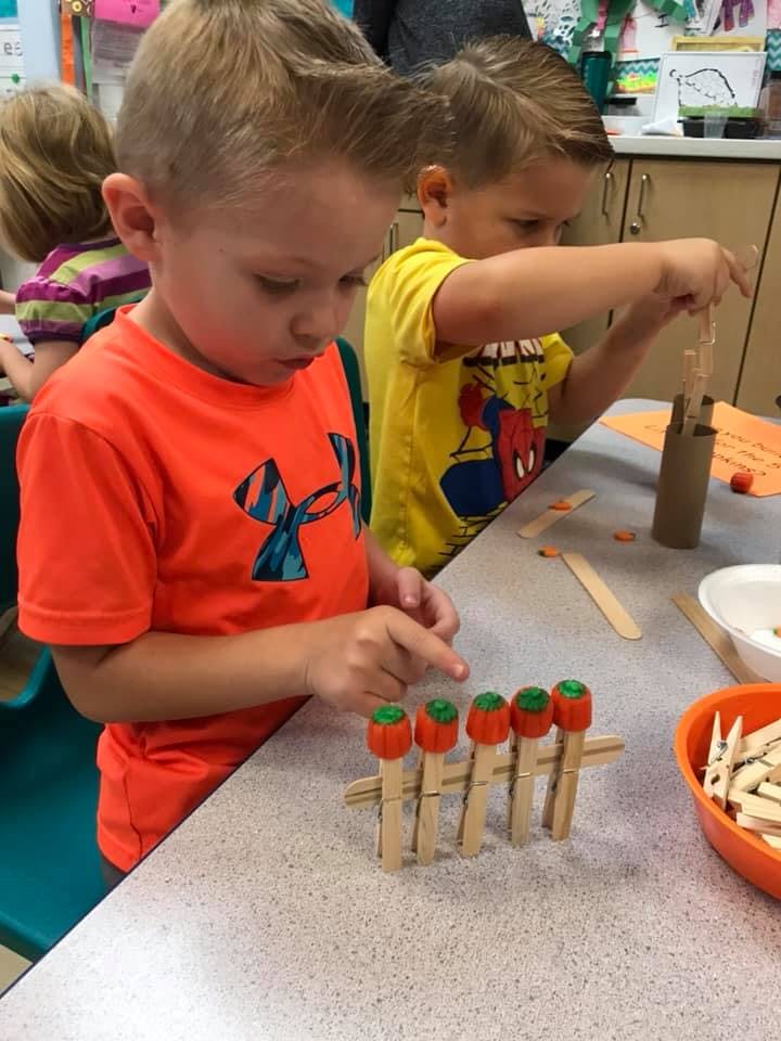 Child working on a craft project at a table