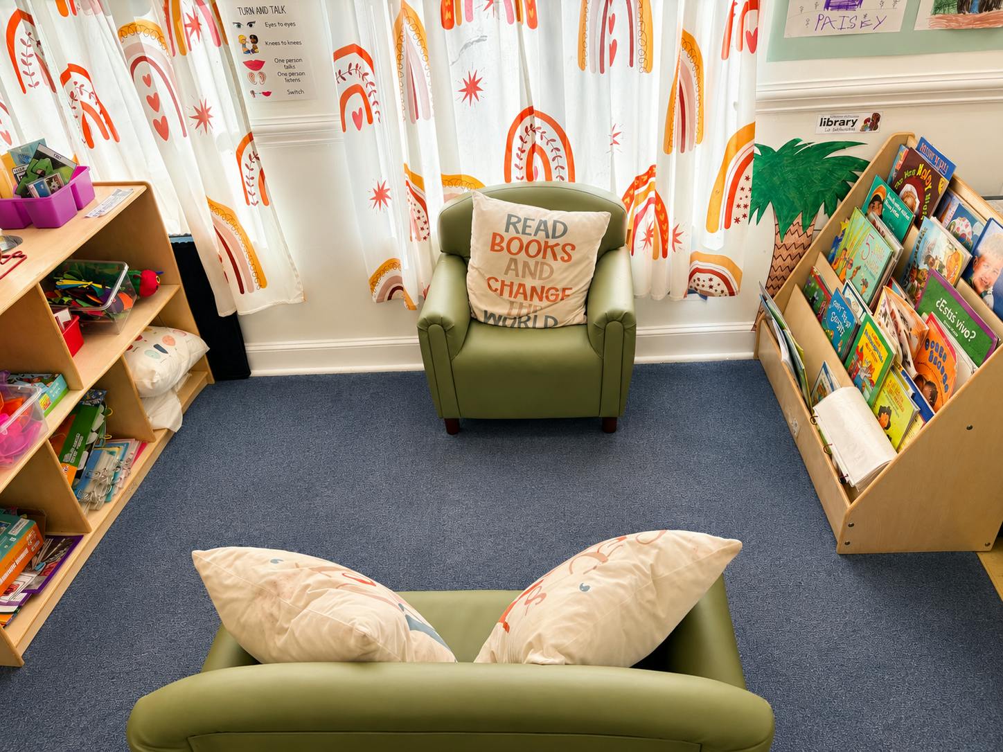 Classroom library corner with two chairs and book storage shelves