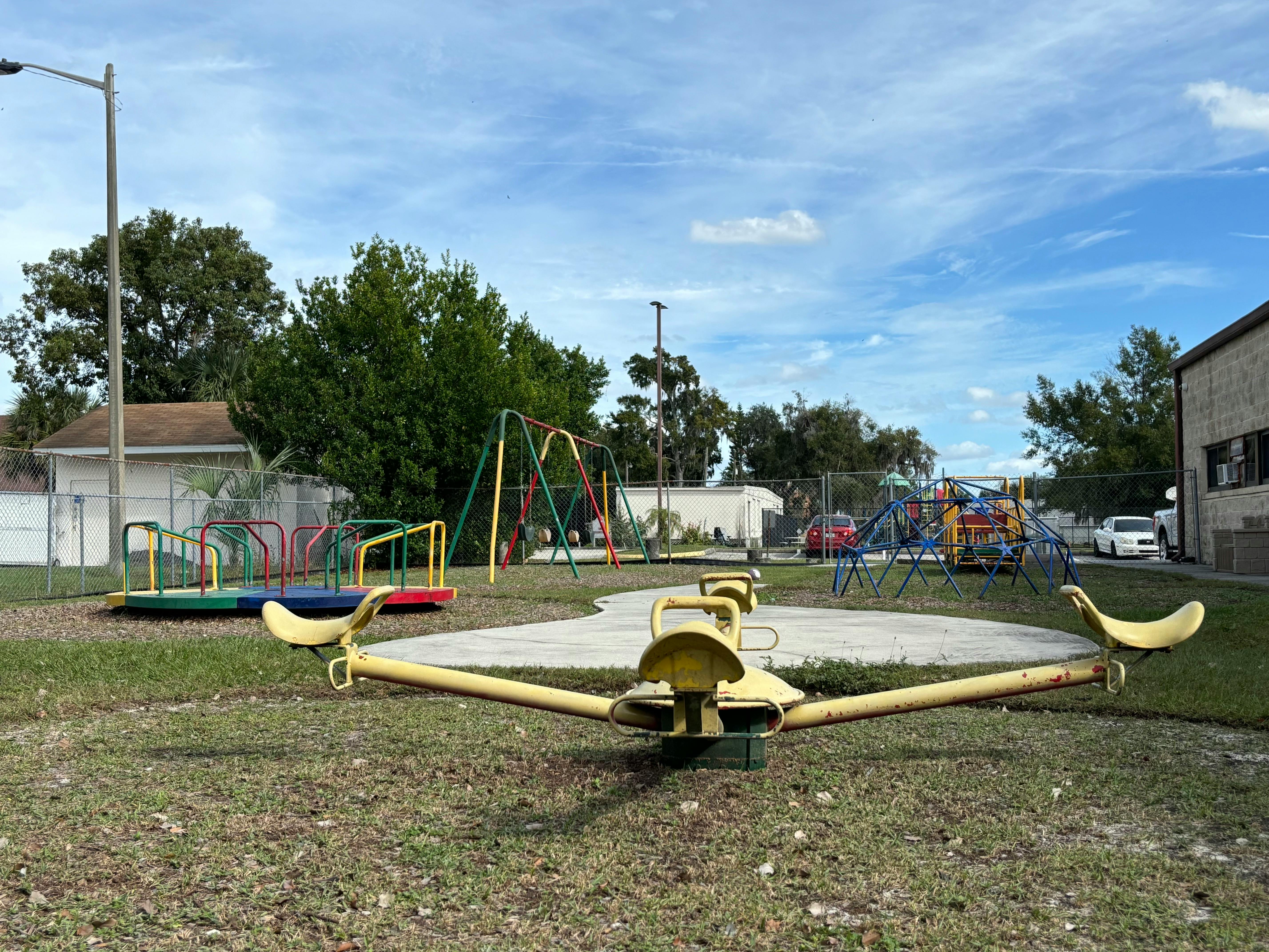 Playground with a yellow seesaw in the foreground