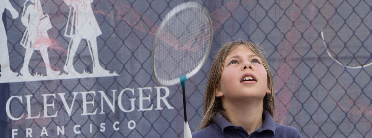 Child looking up with a badminton racket