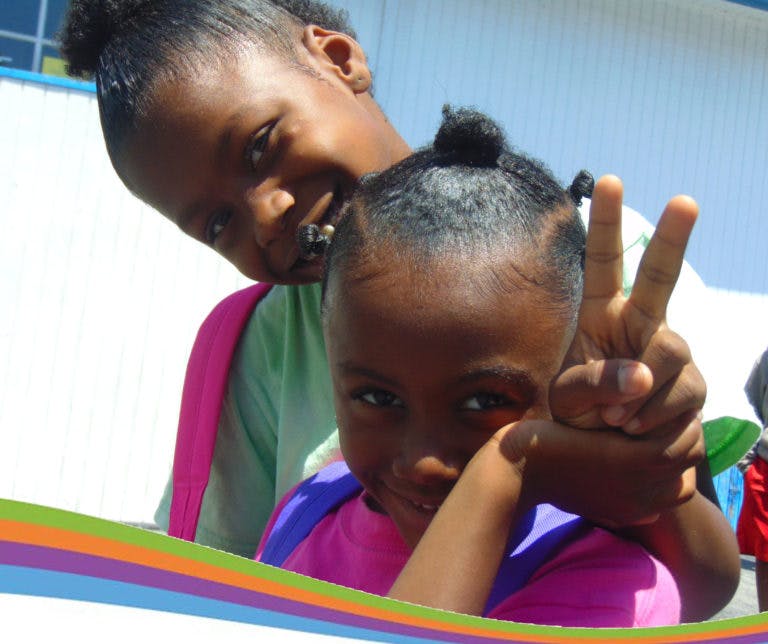 Two children, one making a peace sign