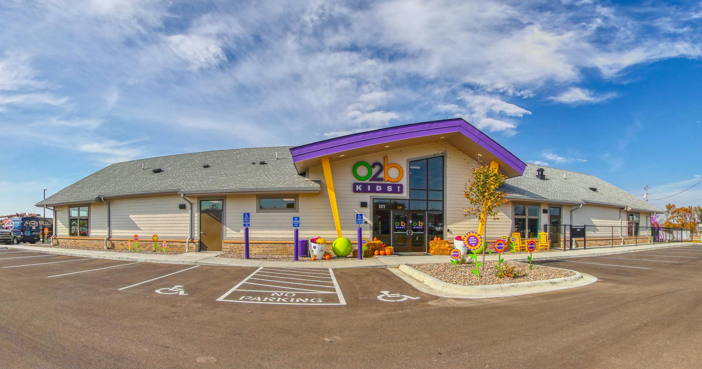 O2B Kids building exterior with parking lot and fall decorations
