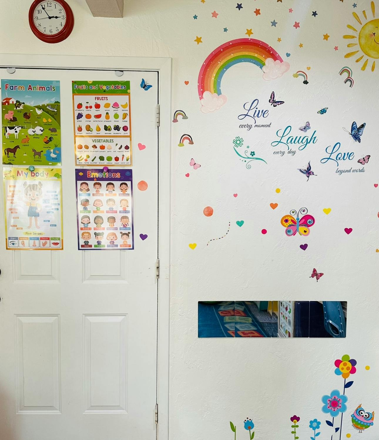 White door with educational charts and a wall with colorful decals