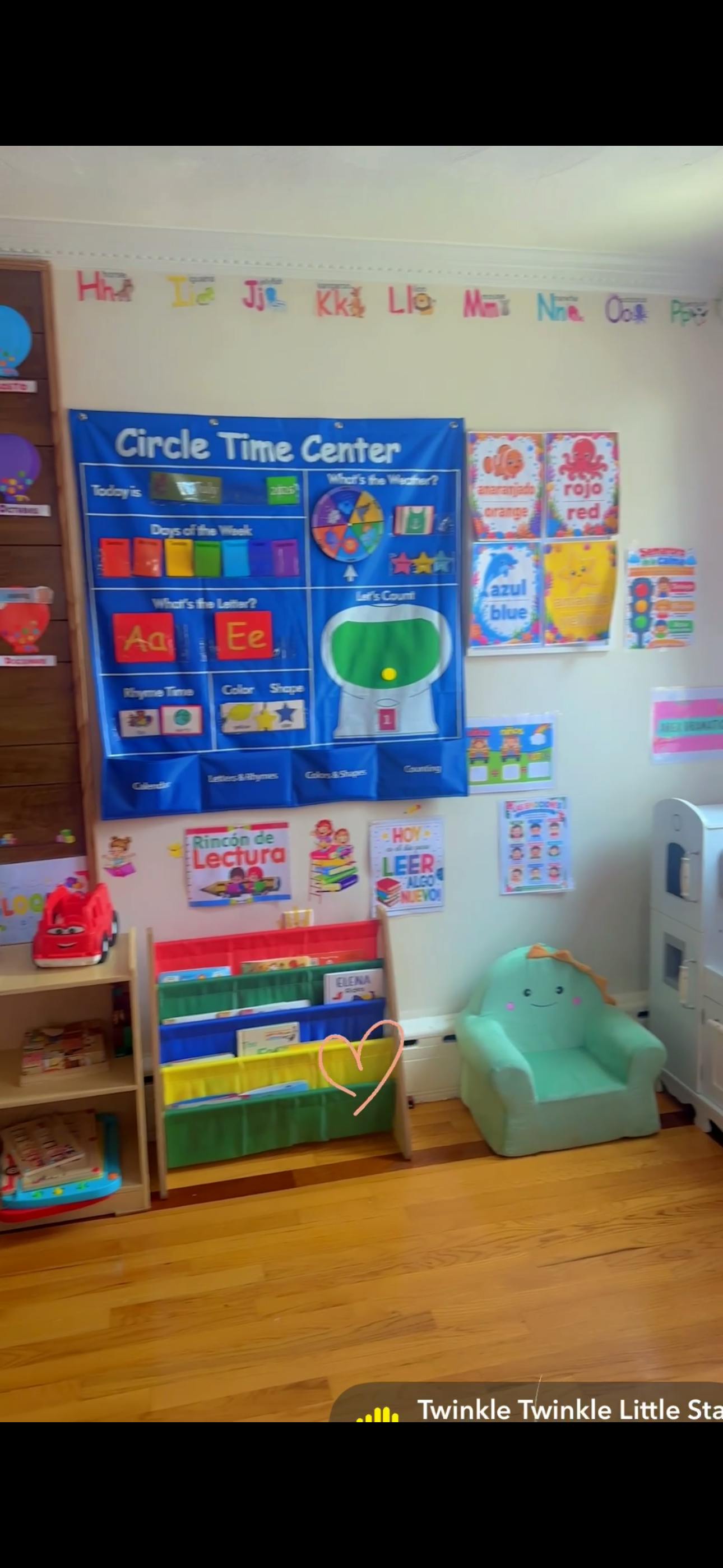 Classroom wall with a Circle Time Center calendar and a book rack