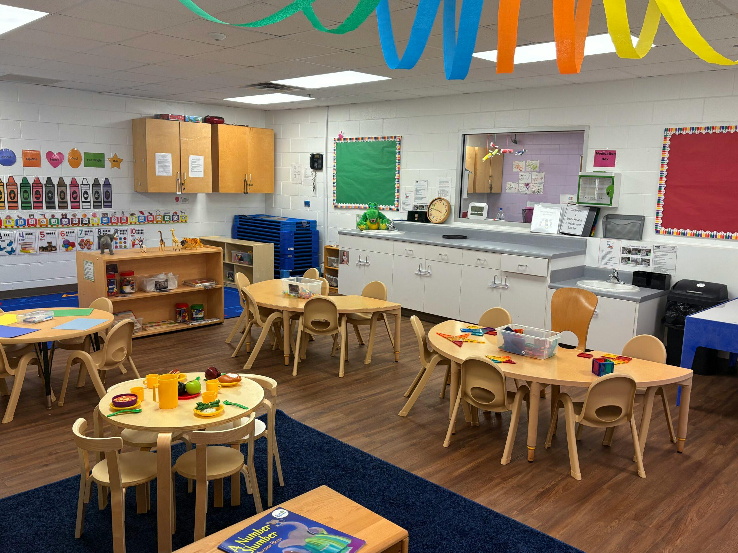 Classroom with small tables and chairs, colorful decorations