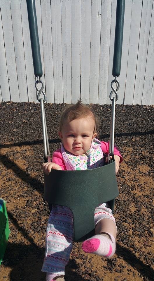 Child in a swing at a playground