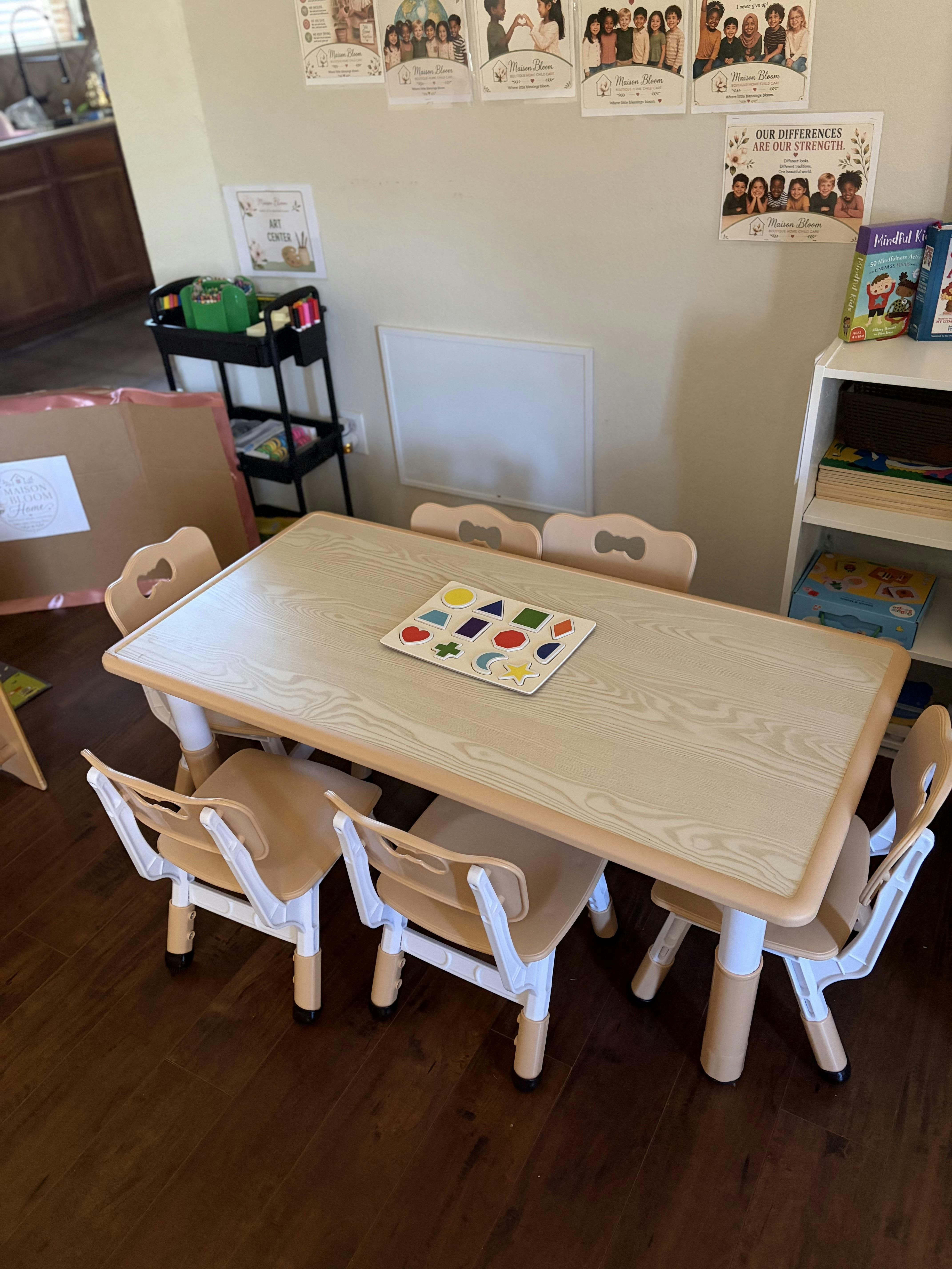Small table and chairs with a shape puzzle in a classroom setting