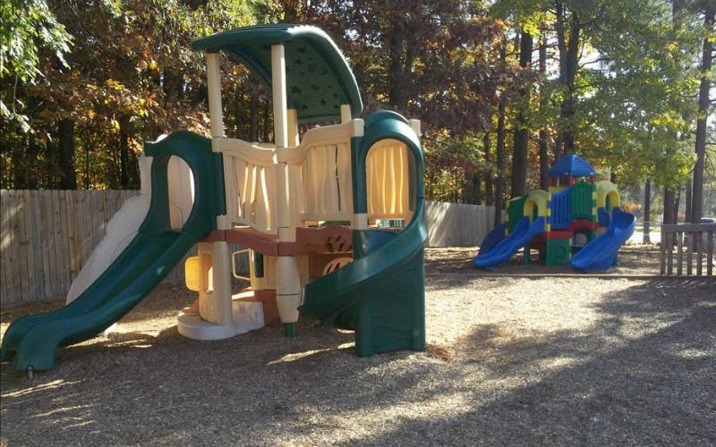 two playgrounds with slides and climbing structures