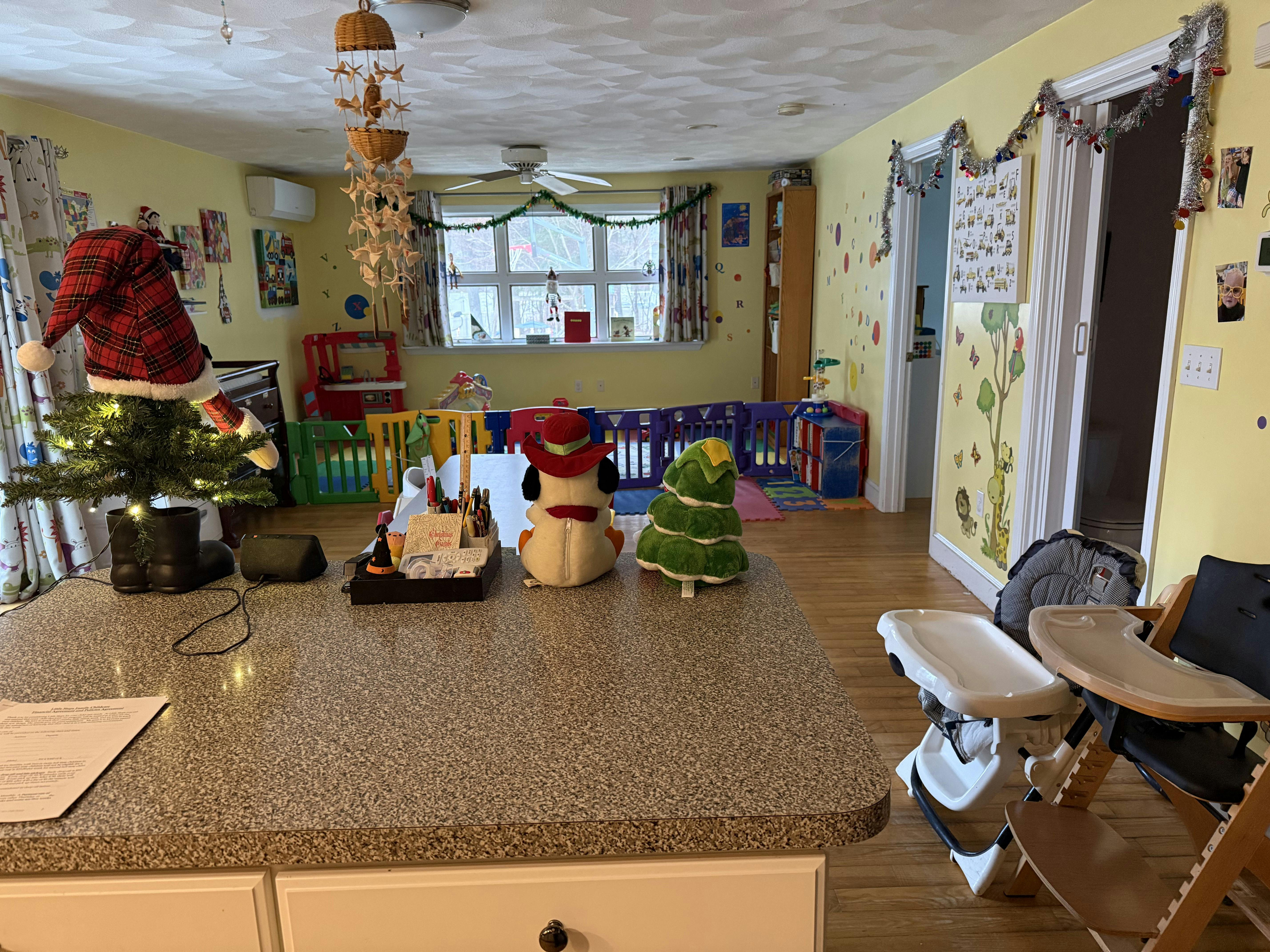 Christmas decorations on a counter in a room with baby gates