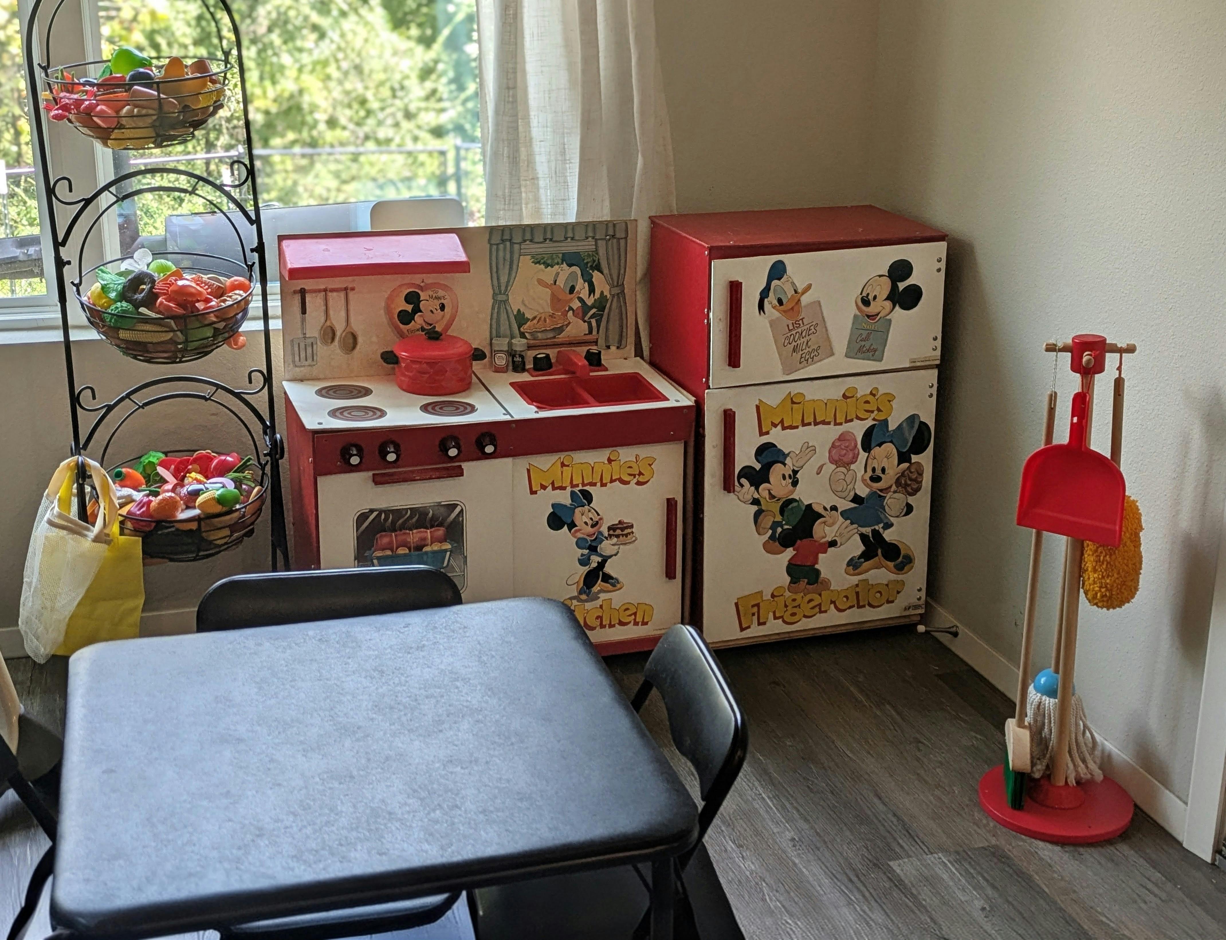 Disney themed toy kitchen set with refrigerator and matching play food rack