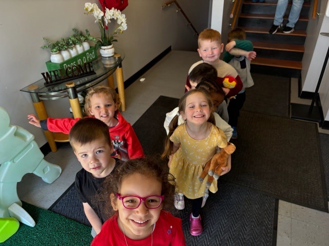 Group of children standing in line inside a building