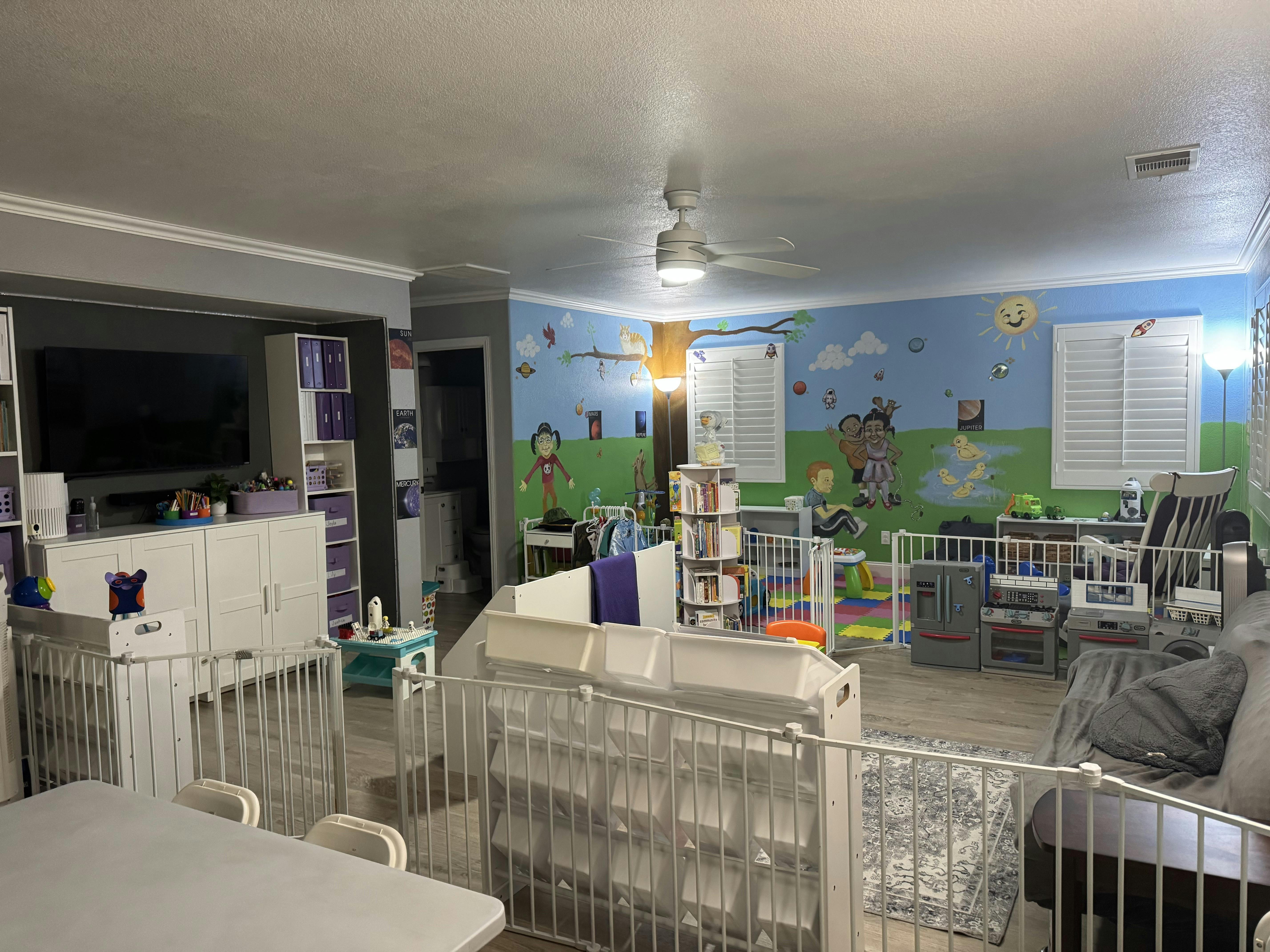 Room with large wall mural and various play and storage areas