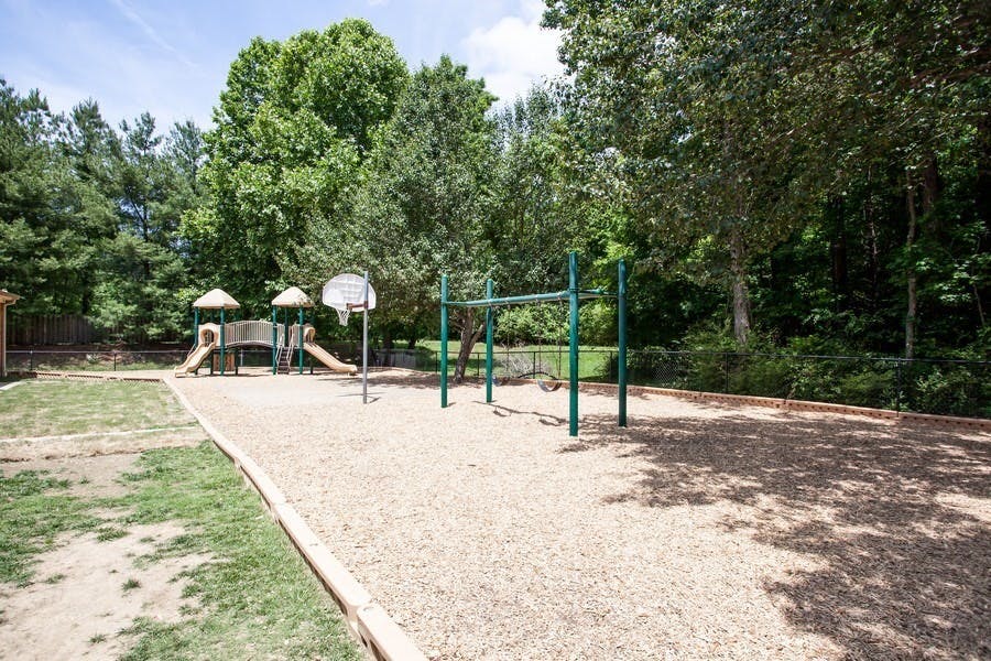Playground with slides, monkey bars, and a basketball hoop