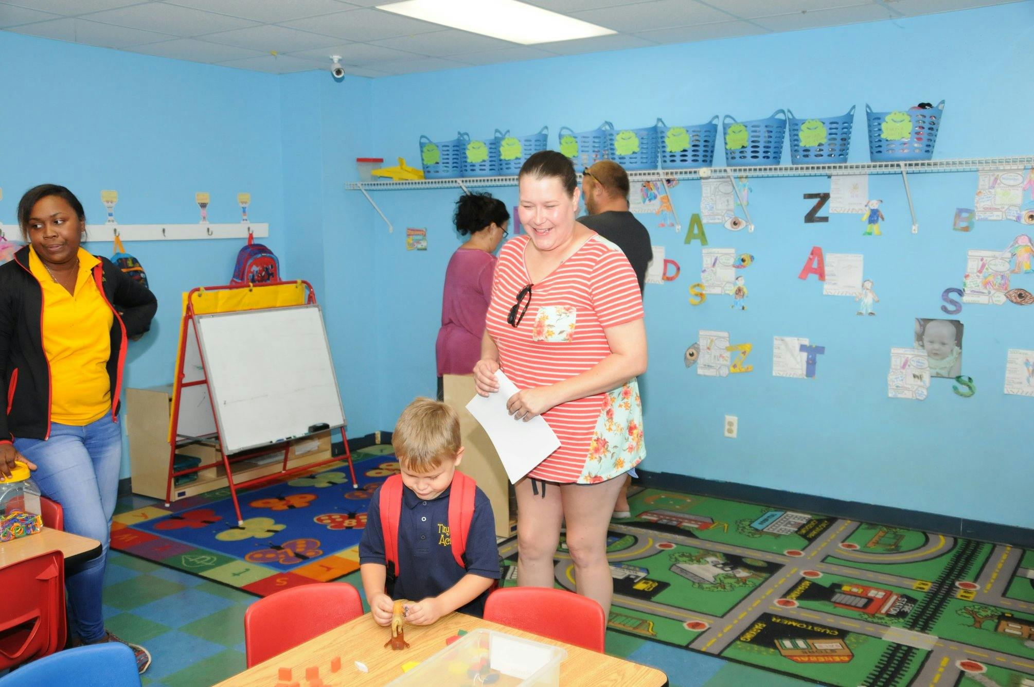 Adults and a child in a classroom