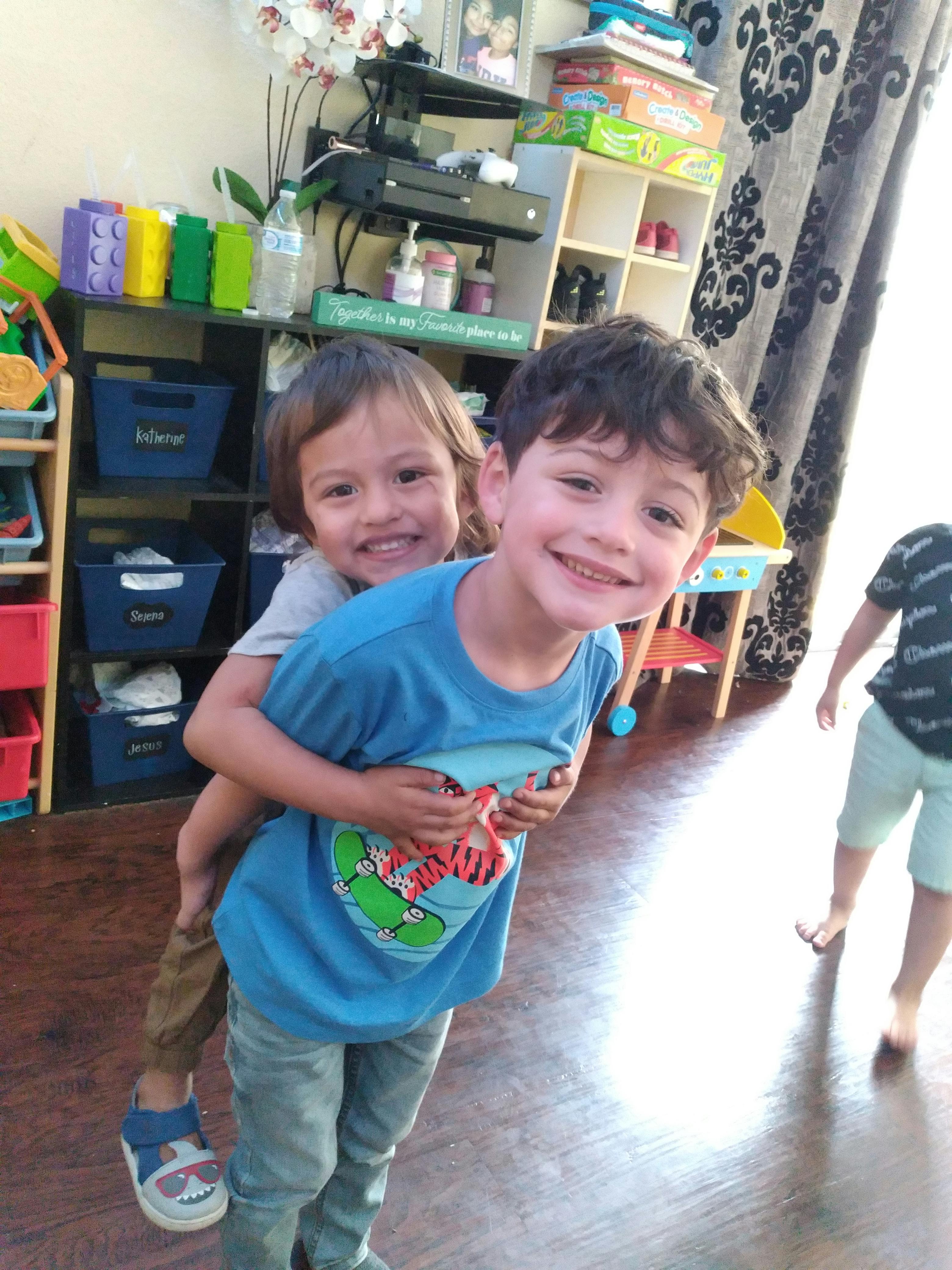 Child giving another child a piggyback ride