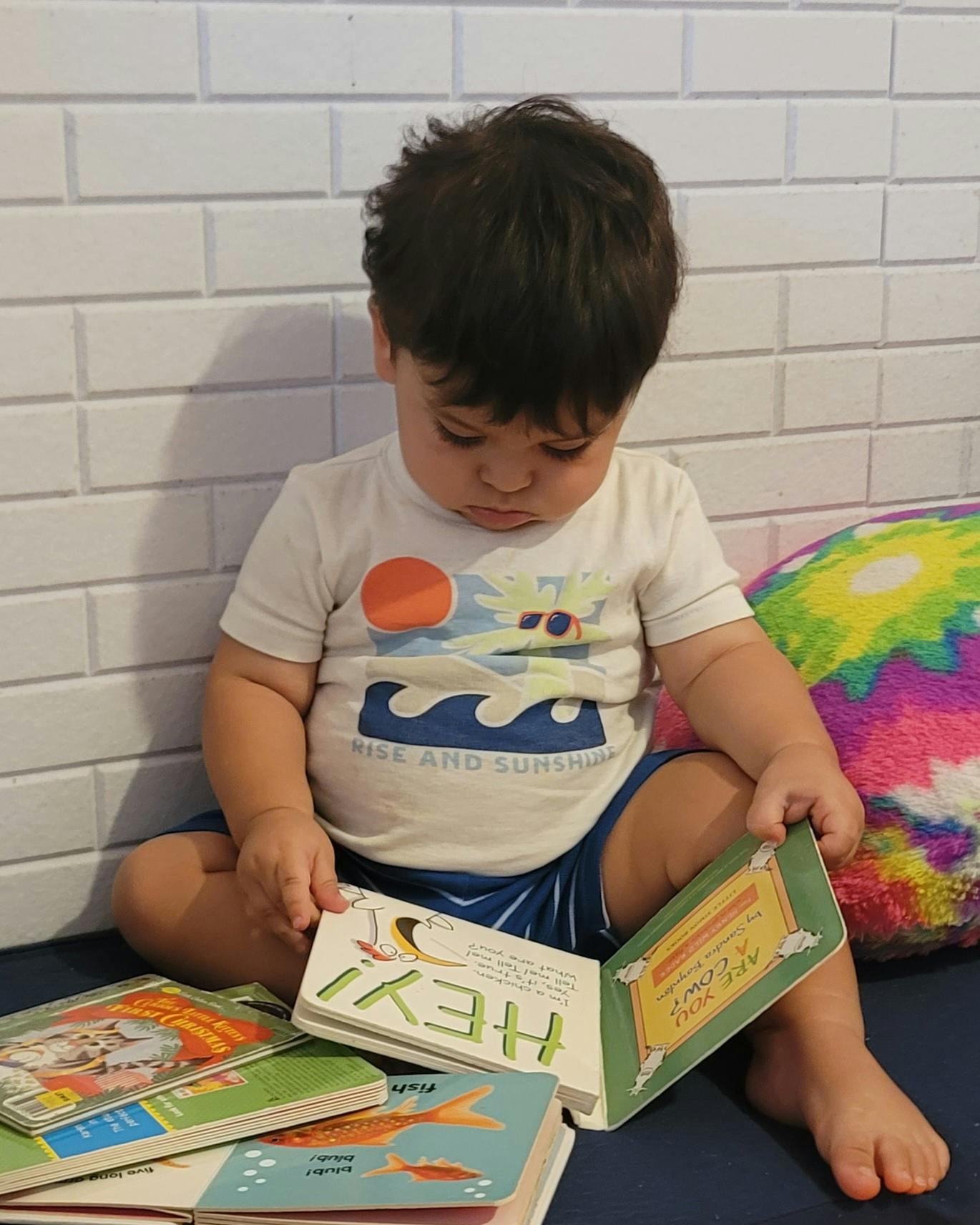 Child sitting on floor reading a book