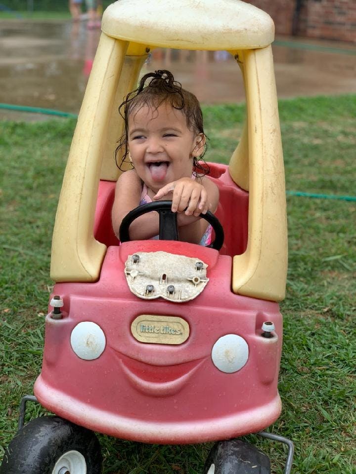 Child in a toy car