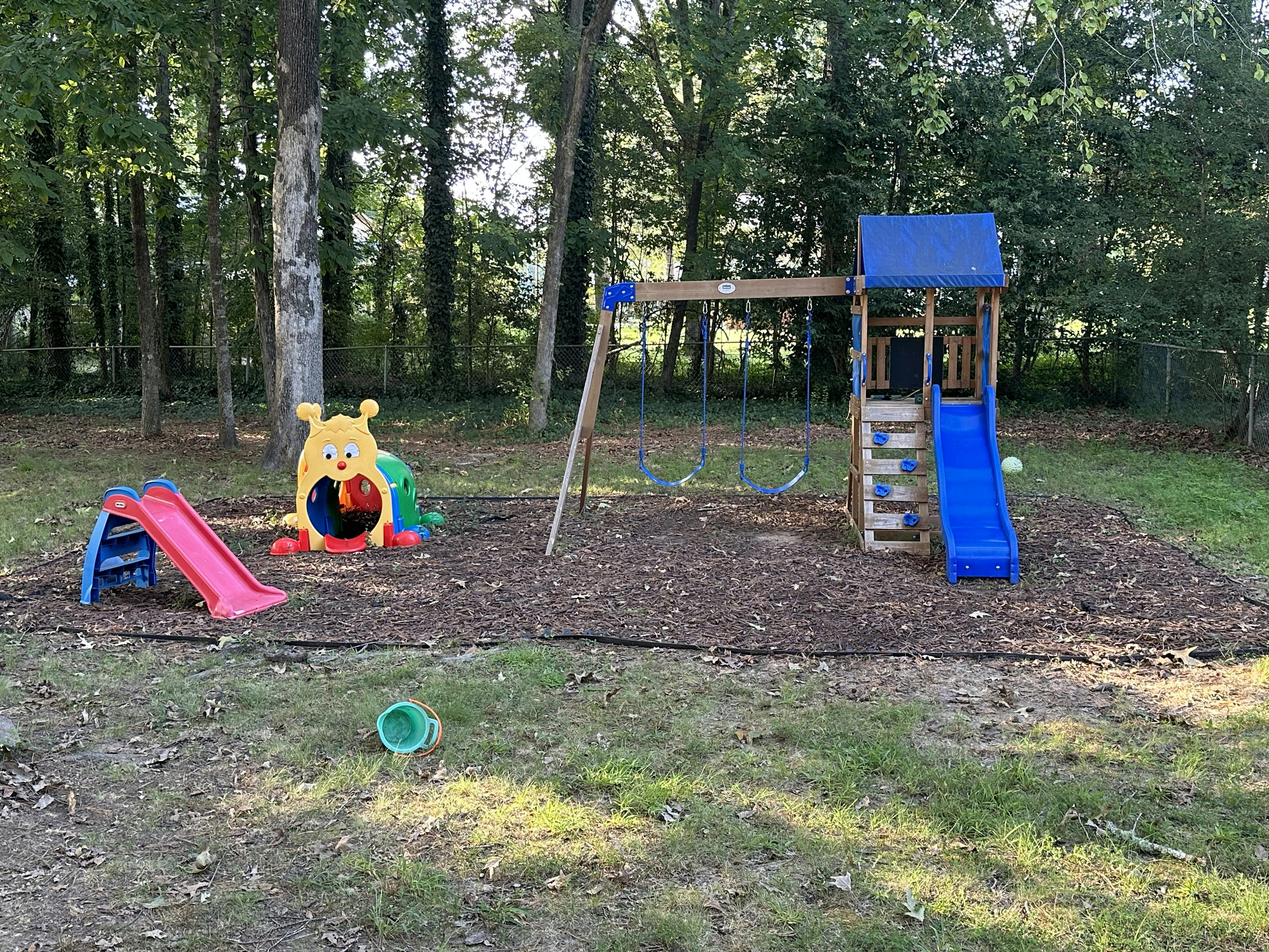 Playground with swings, slides, and a caterpillar tunnel