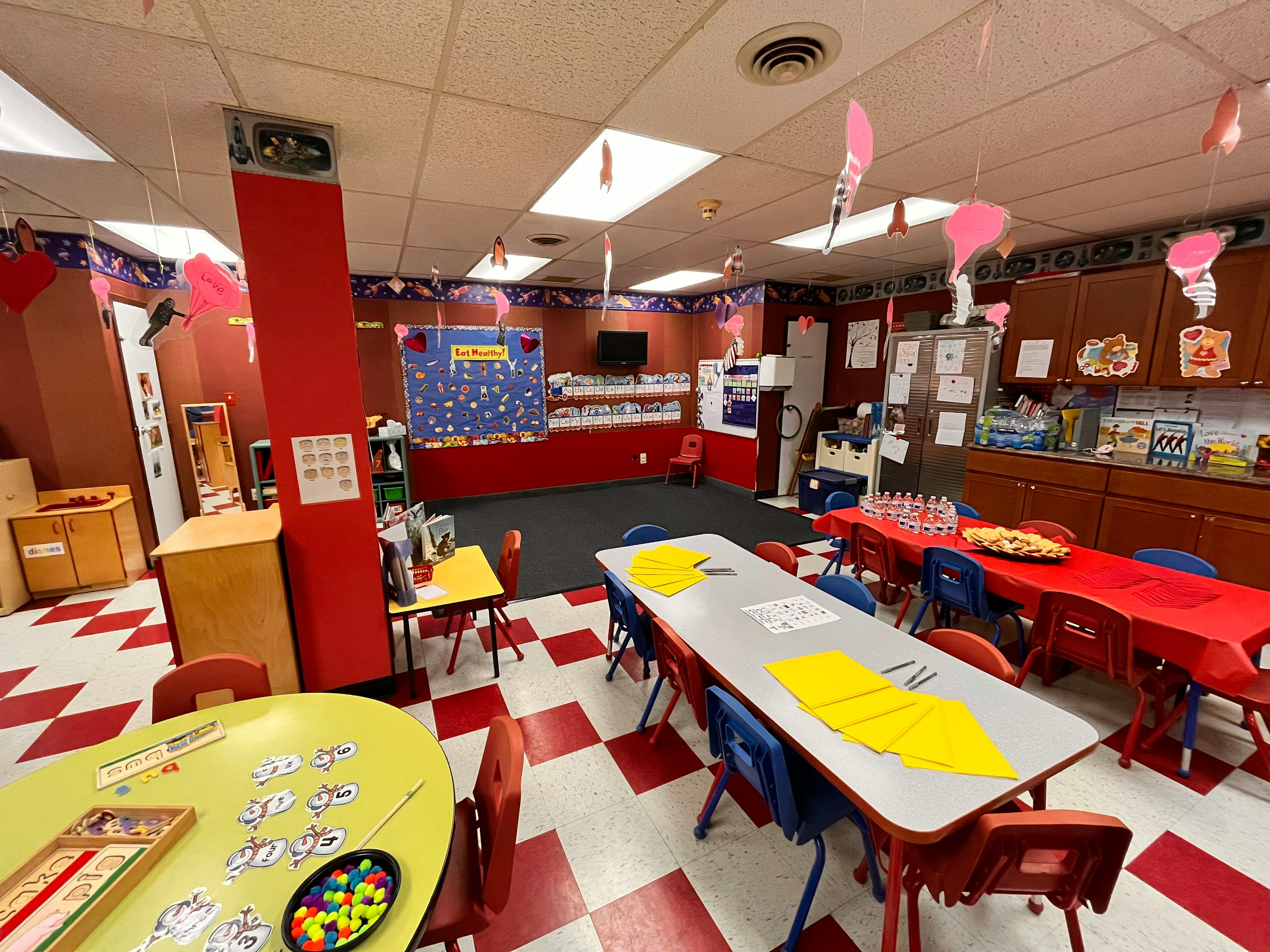 Classroom with tables and chairs, red and white checkered floor