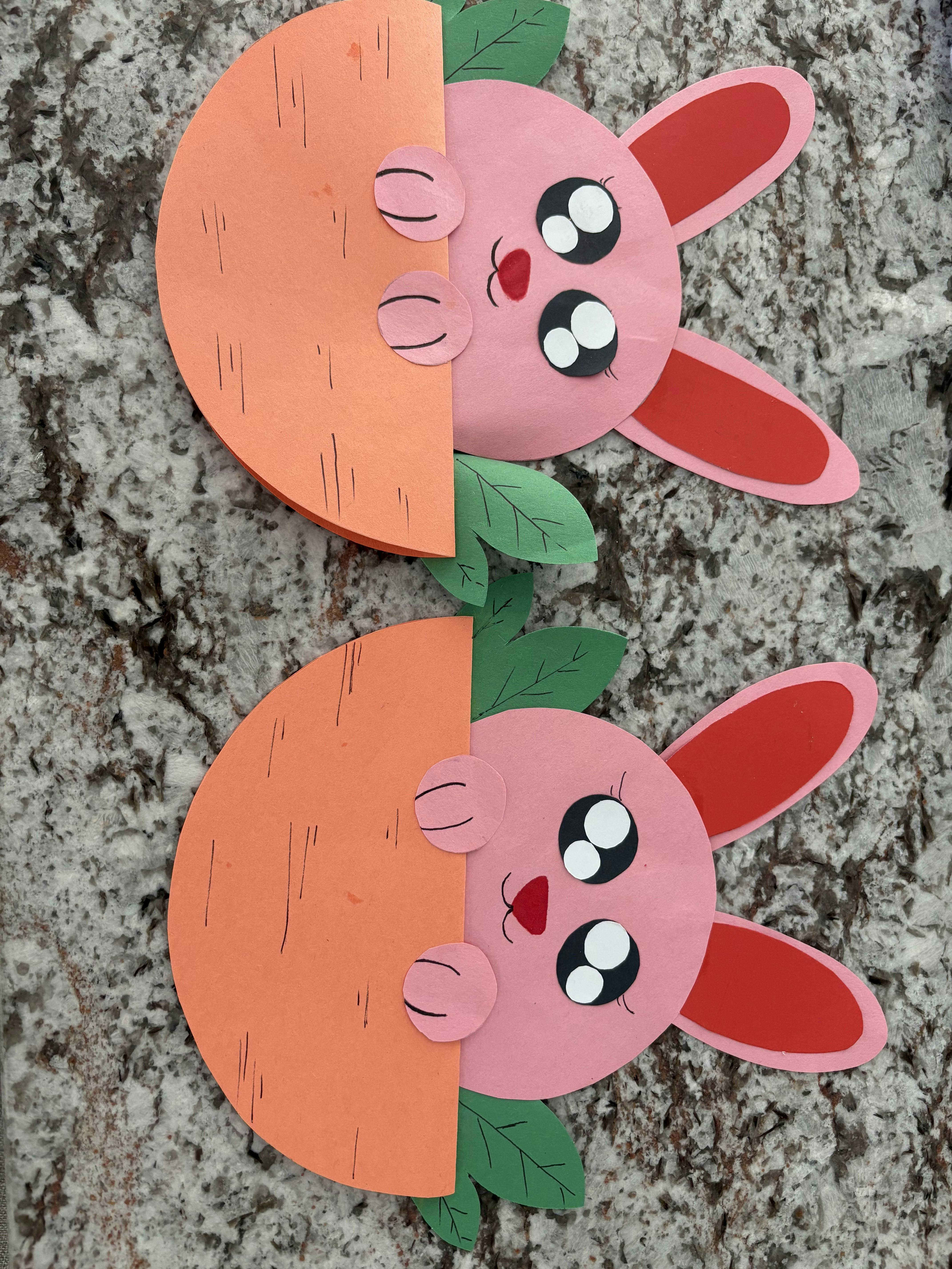 Two paper craft bunnies emerging from paper craft carrots