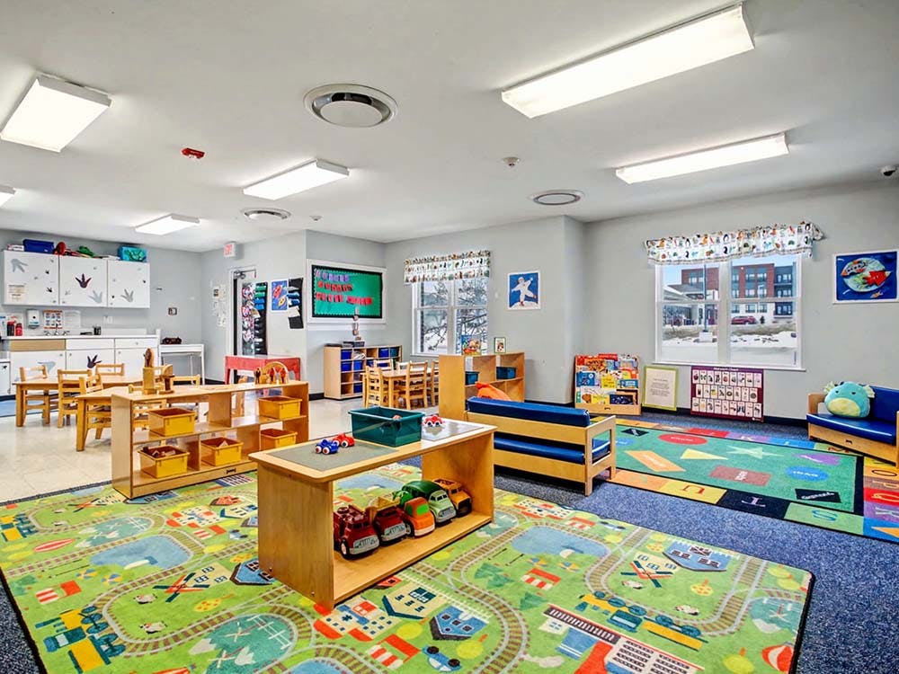 Empty colorful playroom or classroom with tables, chairs, and toys