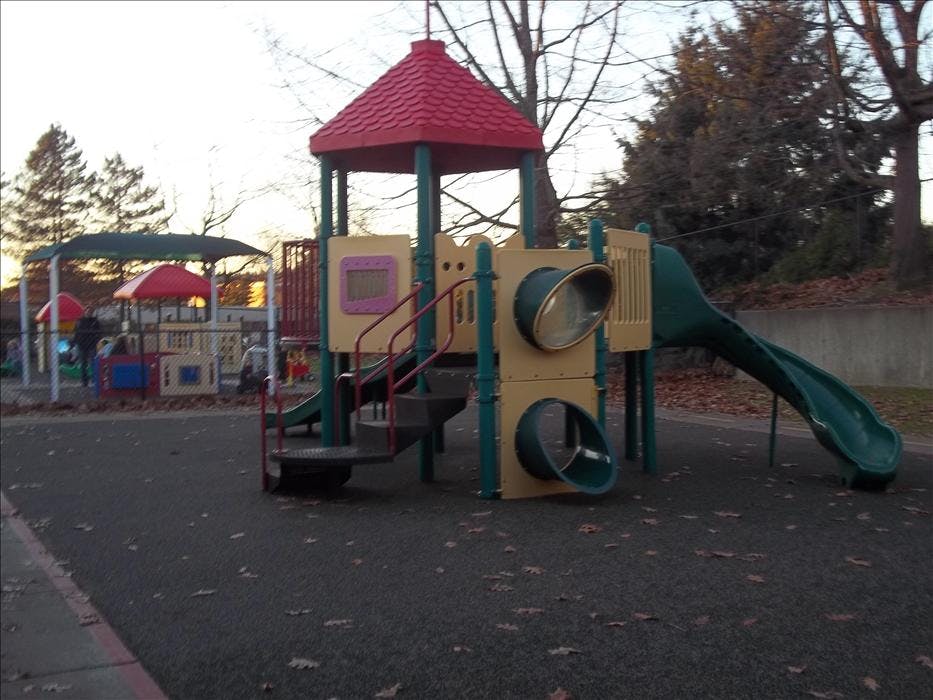 Empty outdoor playground with slides and climbing structures