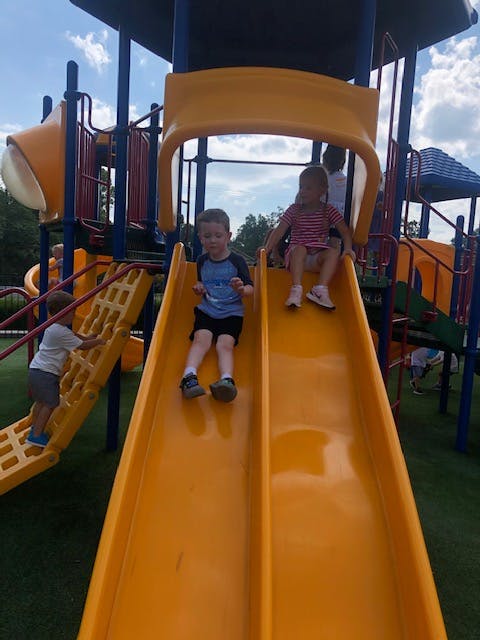 Children on yellow slides at a playground