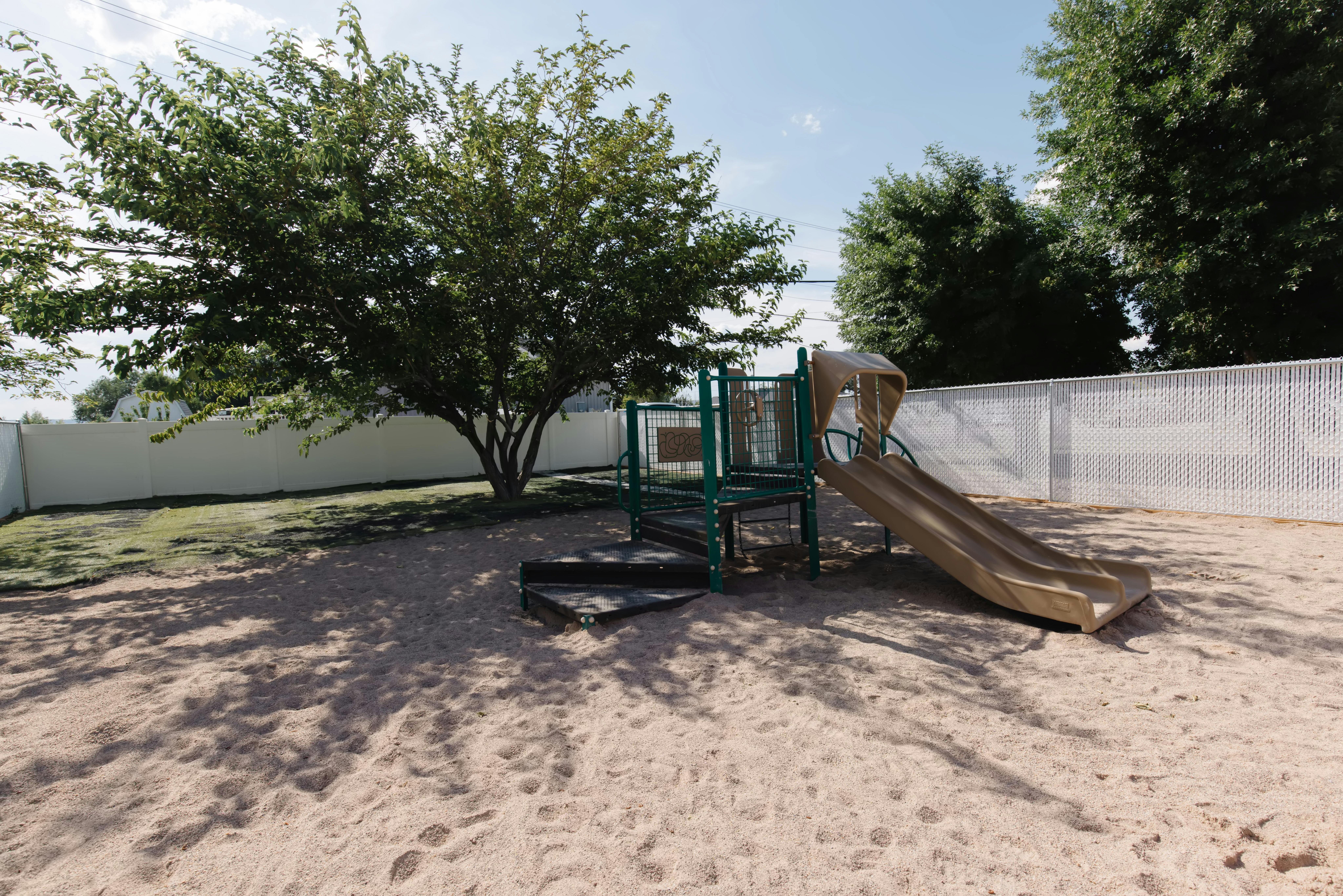 Playground with a slide and climbing structure on sand