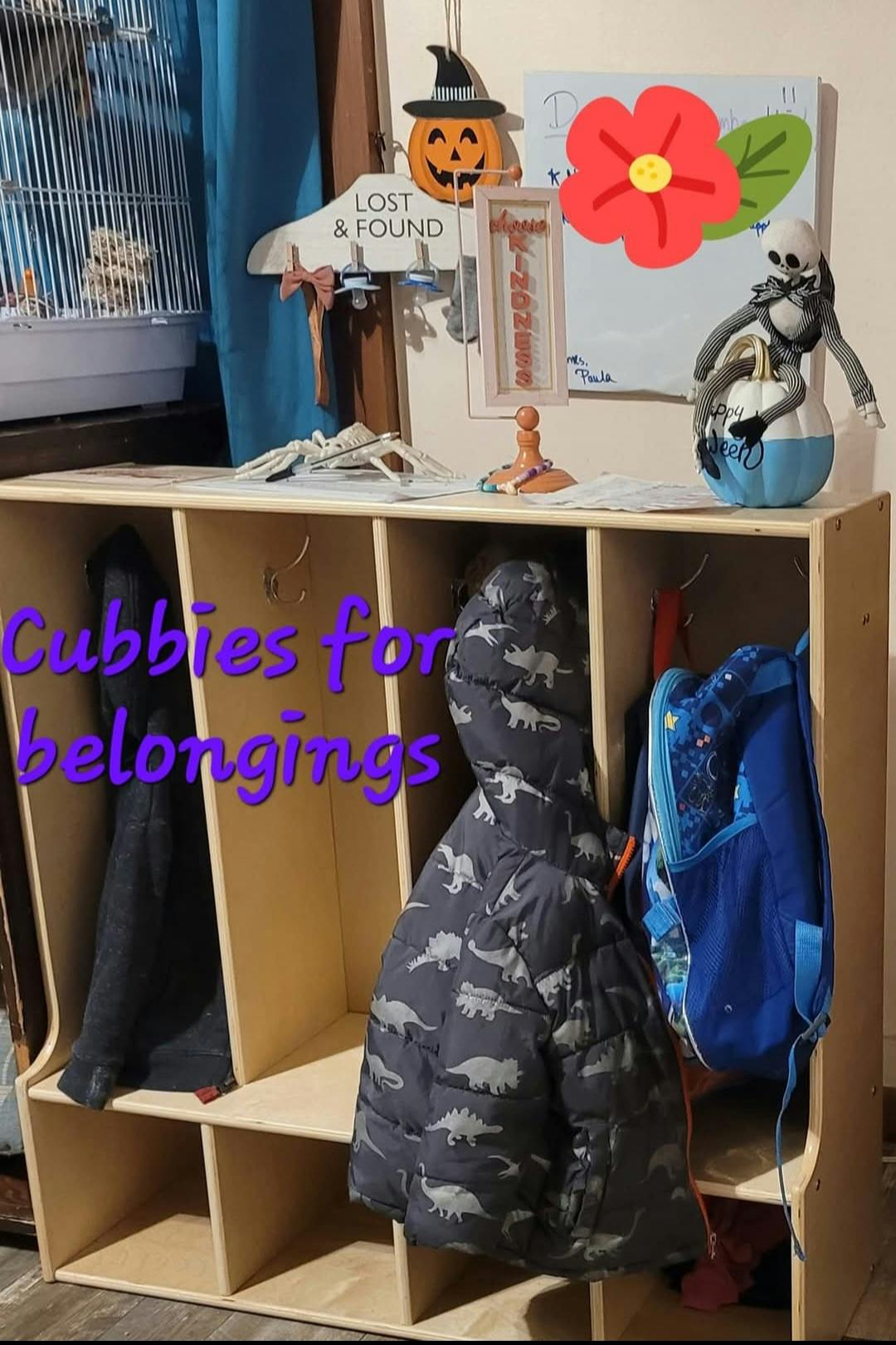 Cubbies with coats and a backpack hanging inside