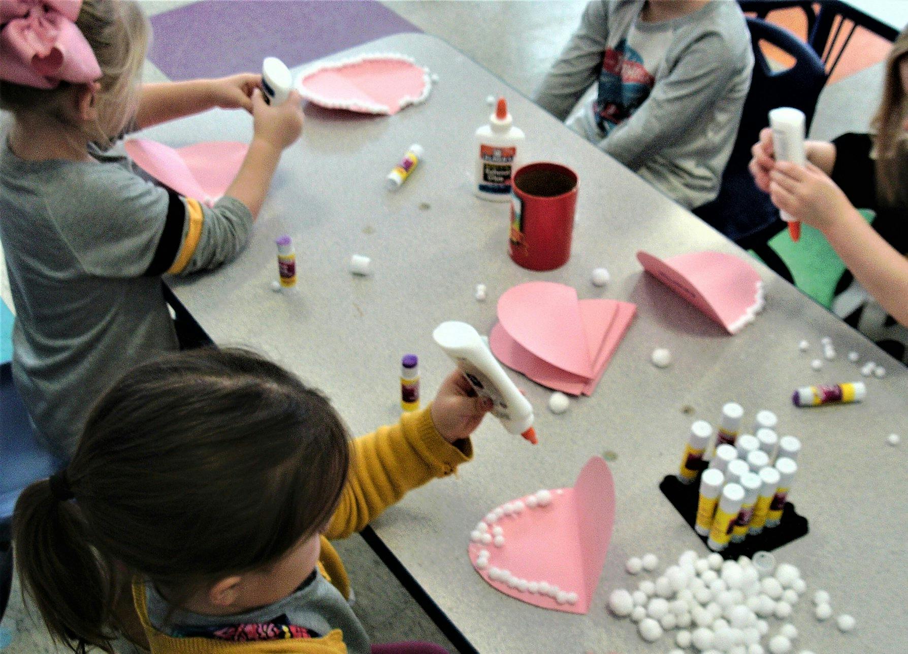 Children doing crafts at a table