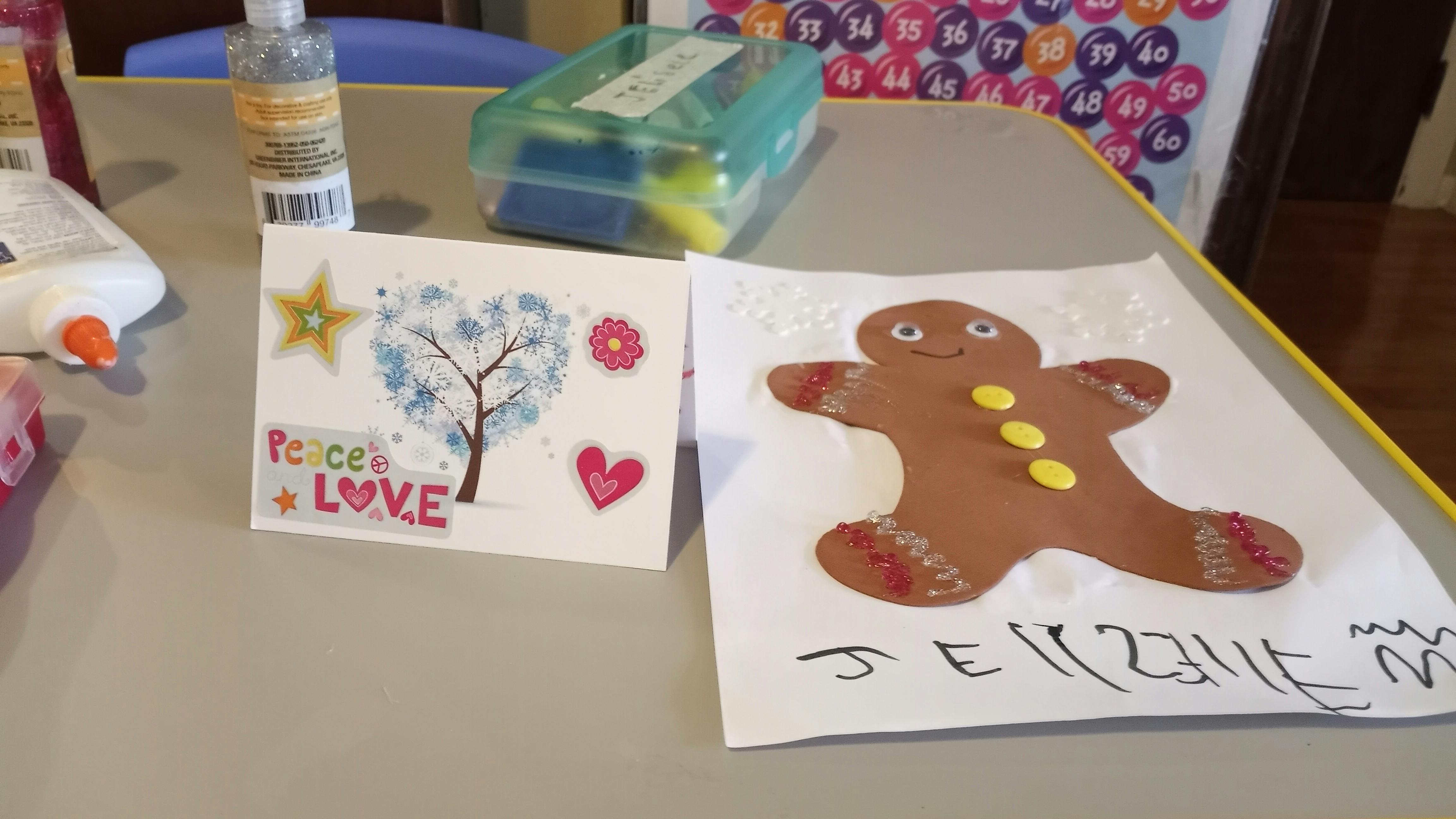 Crafted card with peace and love text next to a gingerbread man drawing
