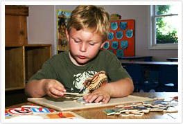 Child working on a puzzle at a table