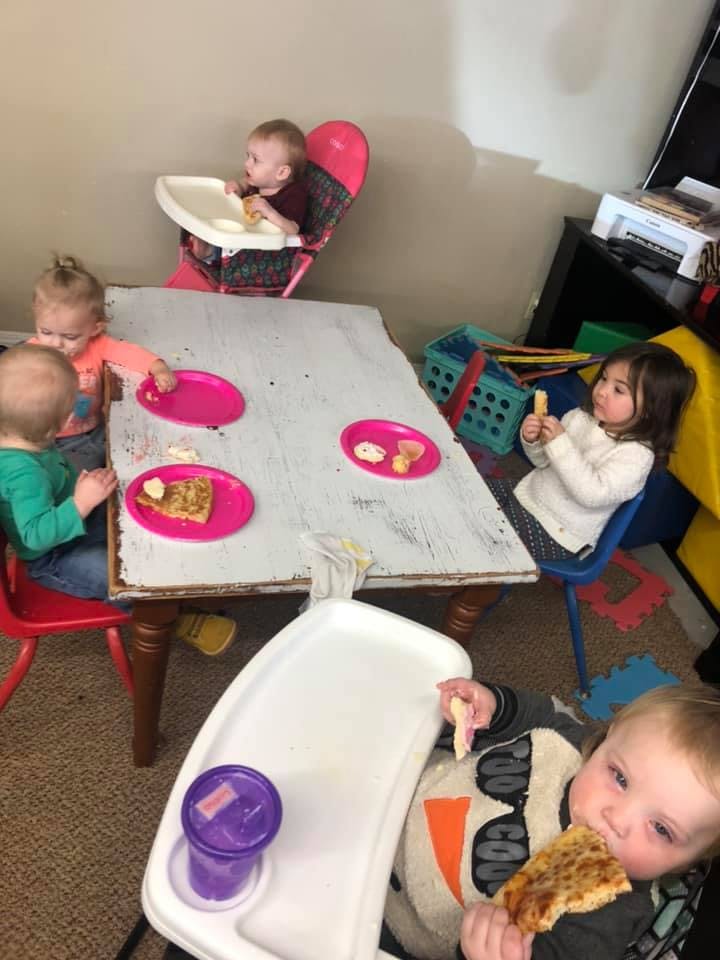 Multiple children eating at a table