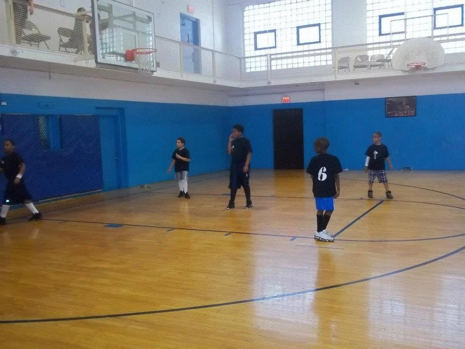 Five people on a basketball court