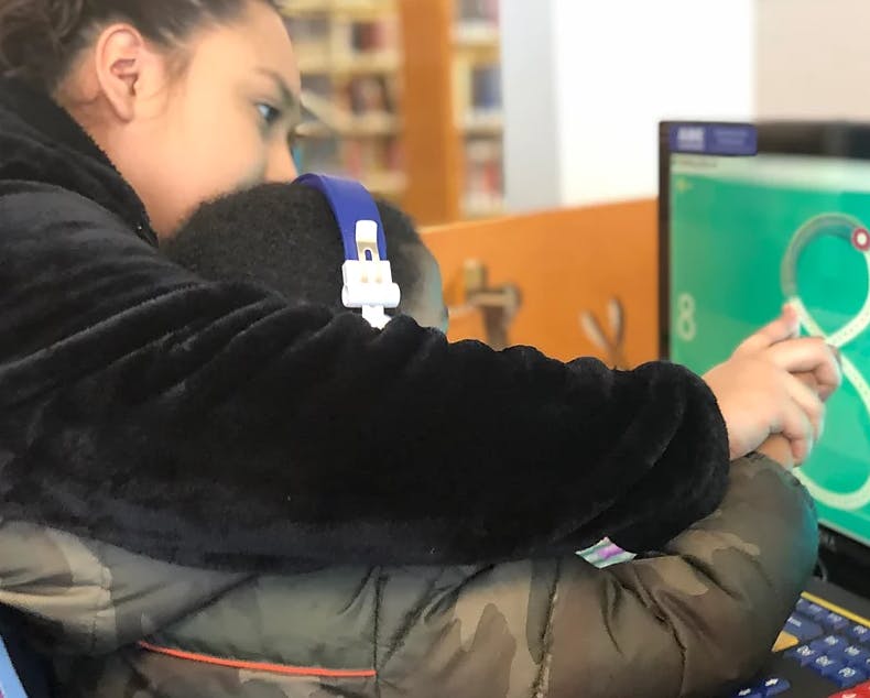 Person and child looking at a computer screen