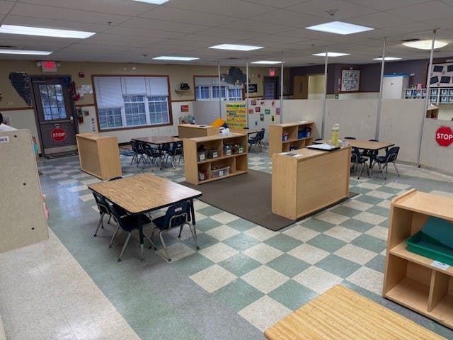 Empty classroom with small tables and chairs
