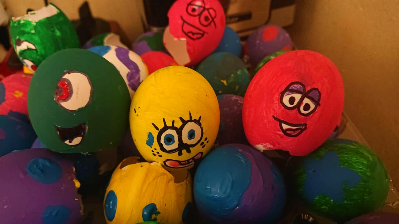 Group of hand-painted decorative eggs with cartoon faces