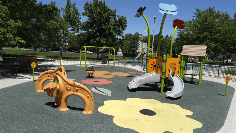 Playground with slides, swings, and flower-shaped ground markings
