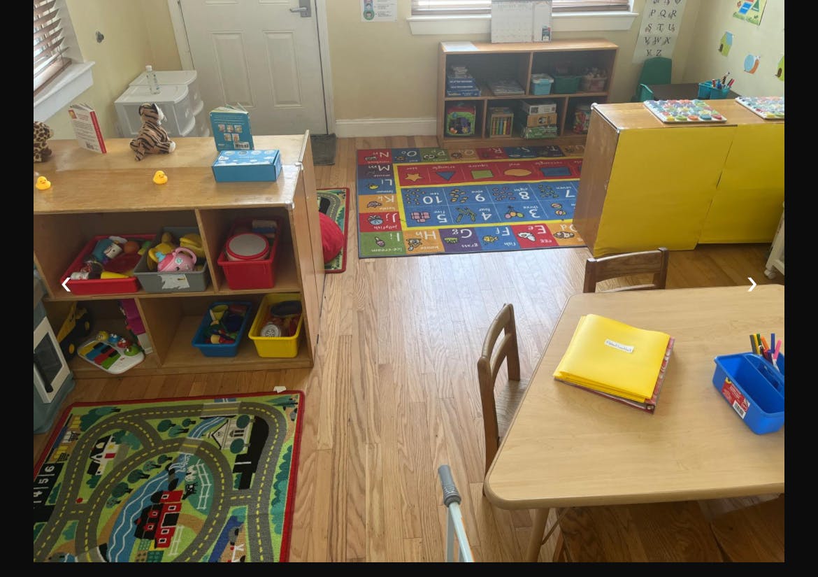 Classroom with small tables, chairs, and toy storage shelves