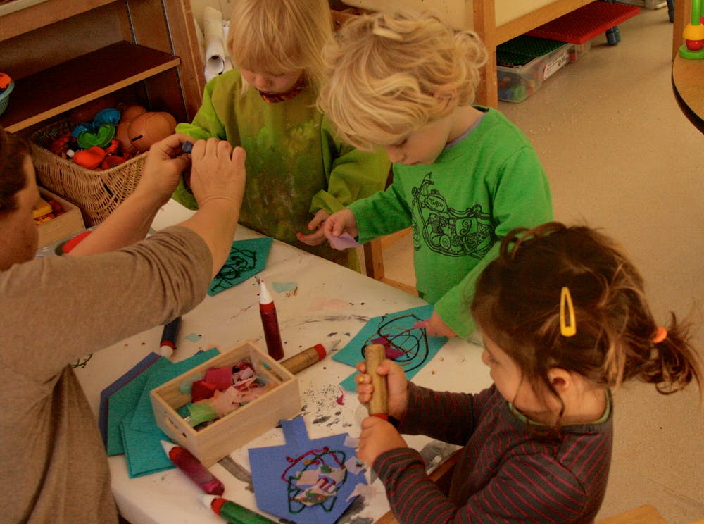 Adult and three children crafting at a table