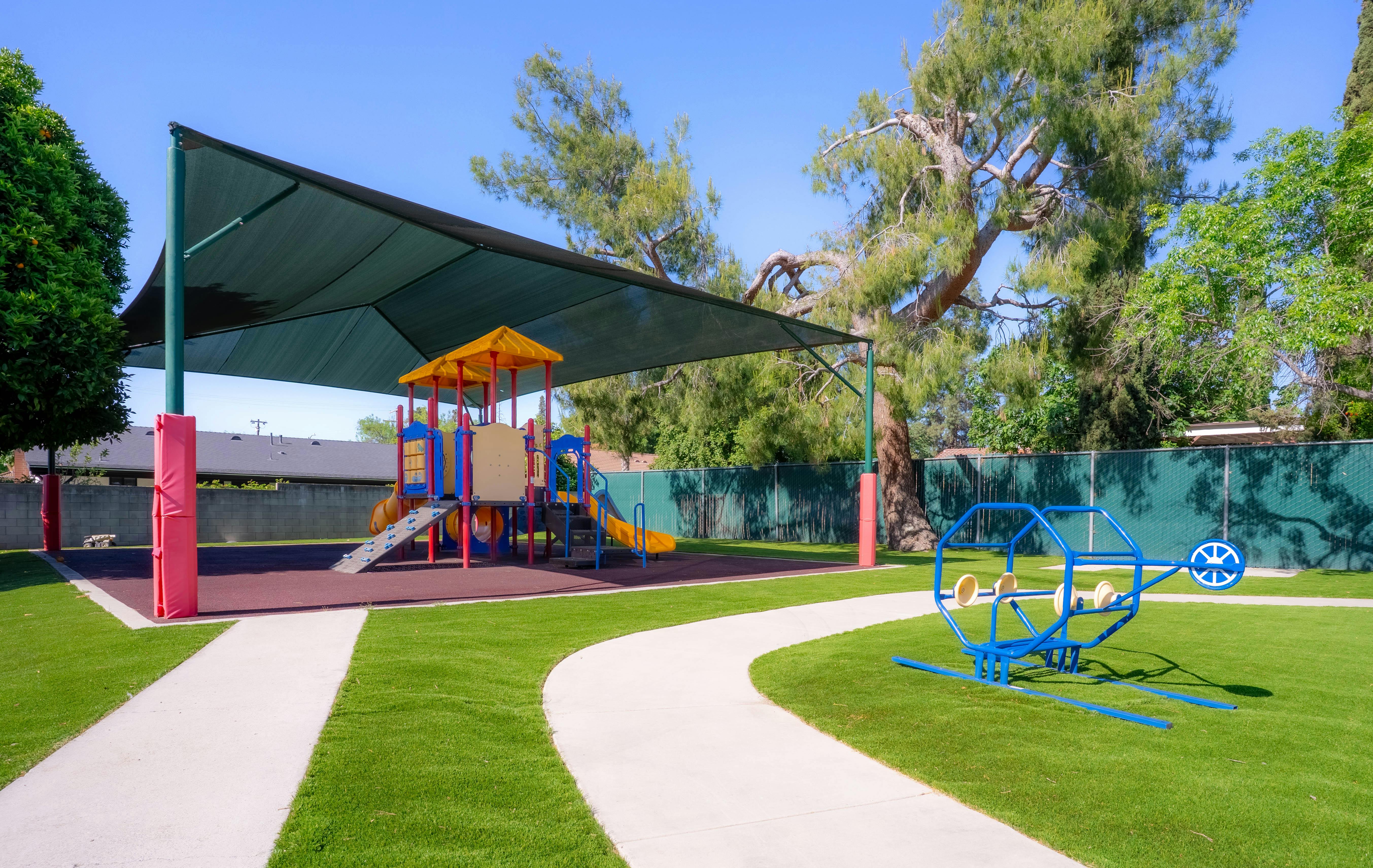 Playground with shade structure and play equipment