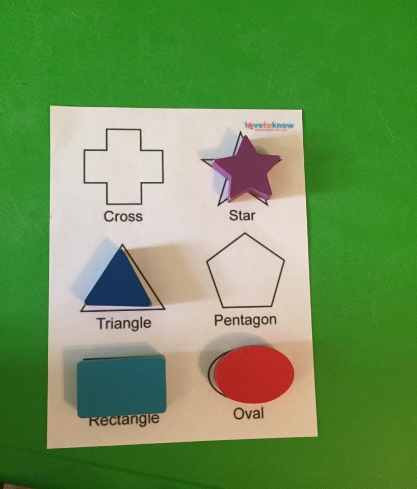 Shape sorter with cross, star, triangle, pentagon, rectangle, and oval